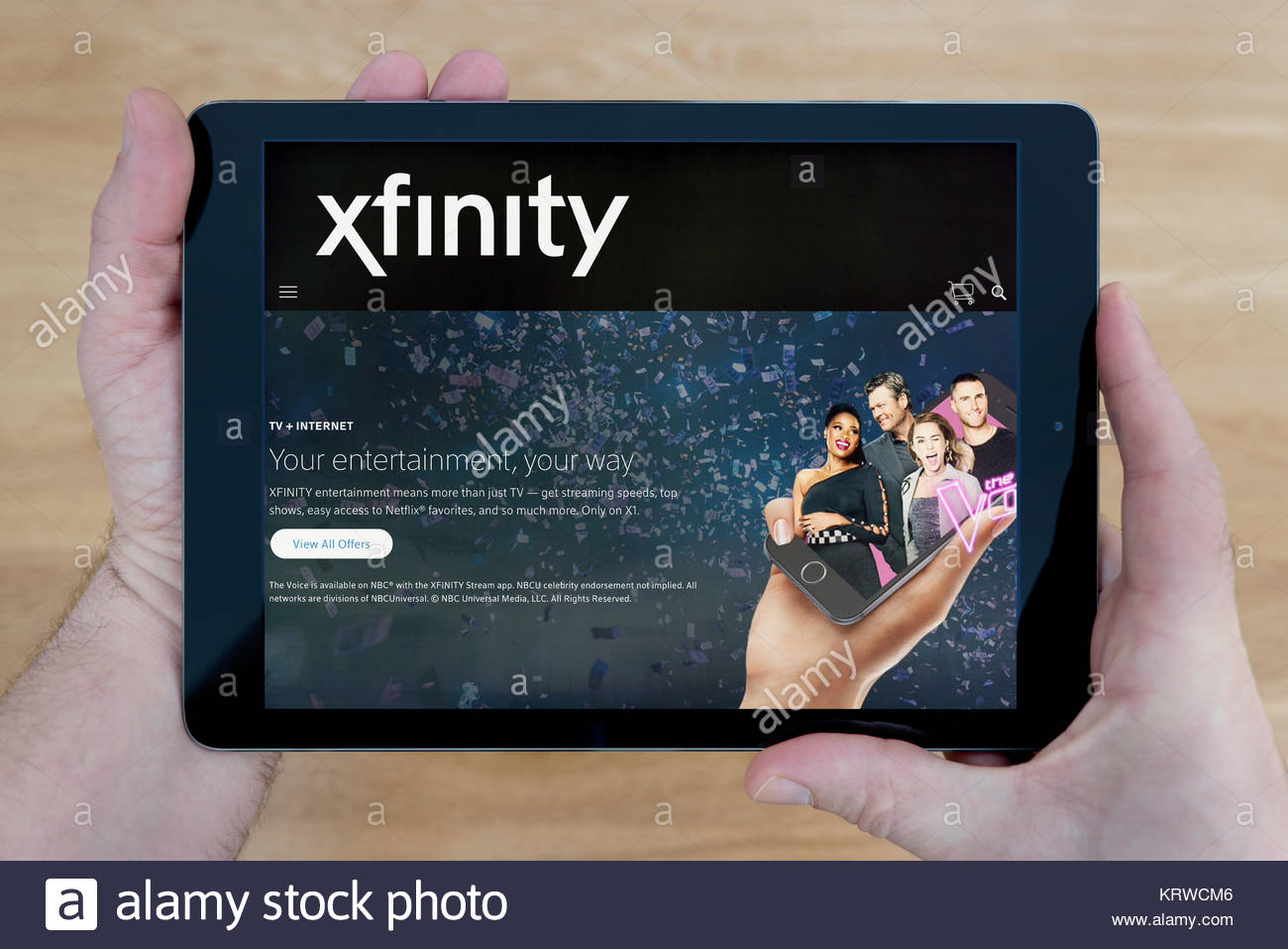 A Man Looks At The Xfinity Website On His iPad Tablet Device Shot