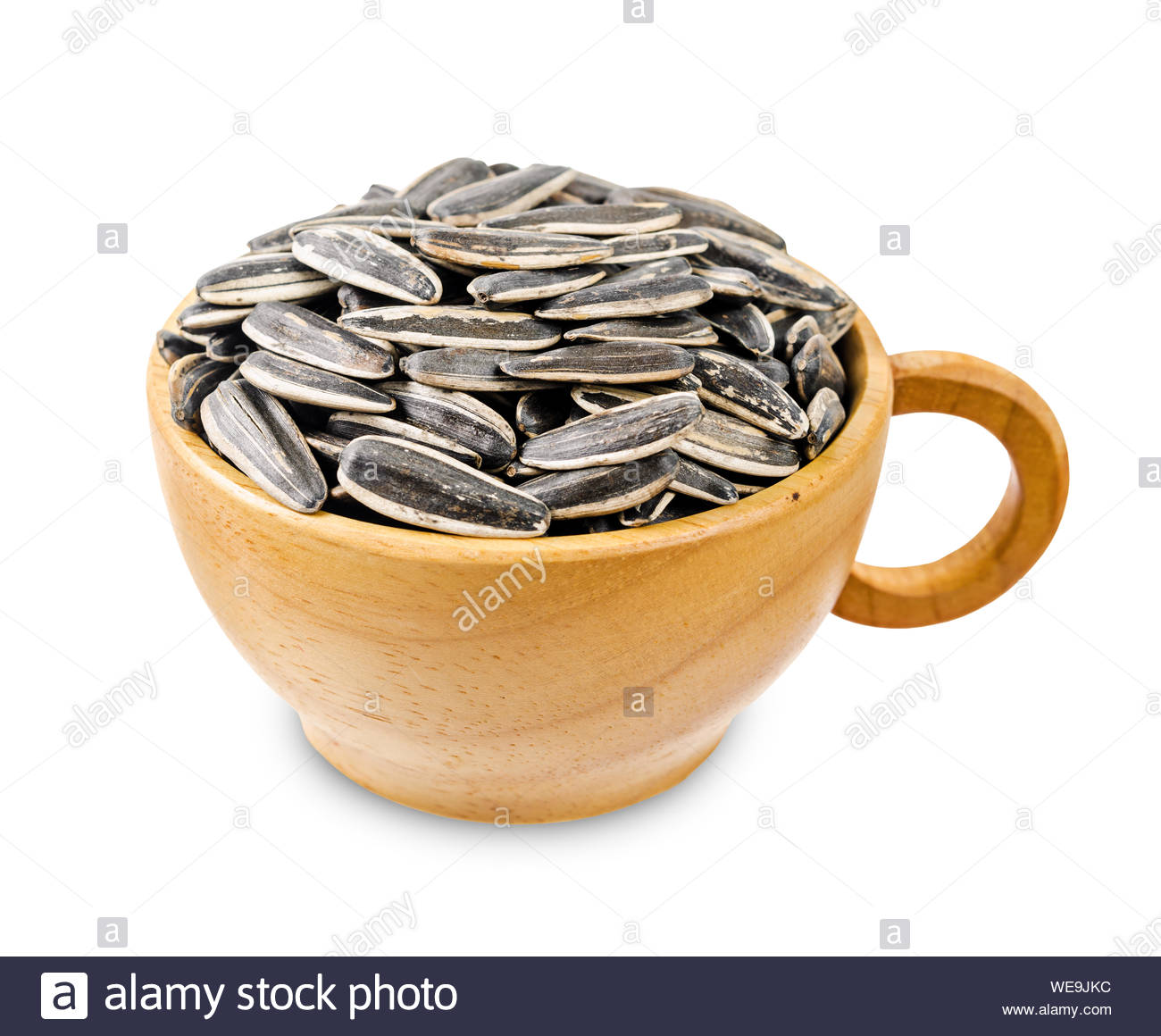 Dried Ripe Sunflower Seeds In Wooden Cup Isolated On White