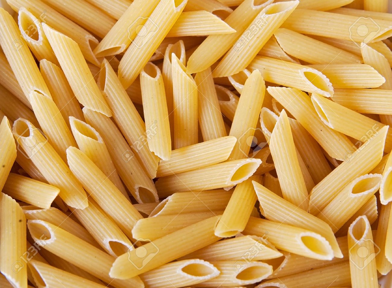 Macro Closeup Of Penne Pasta Background Texture Stock Photo