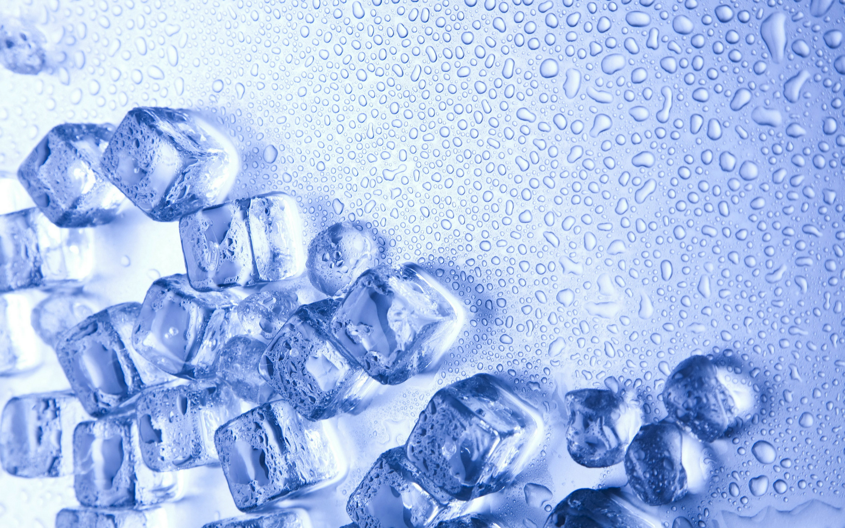 Close-up of ice cubes on a surface covered with water droplets, creating a refreshing and cool visual