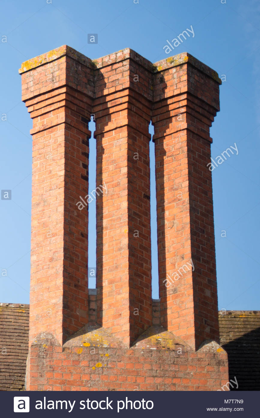 Tudor Chimney Stacks With Ancient Tiled Roof In Background Stock