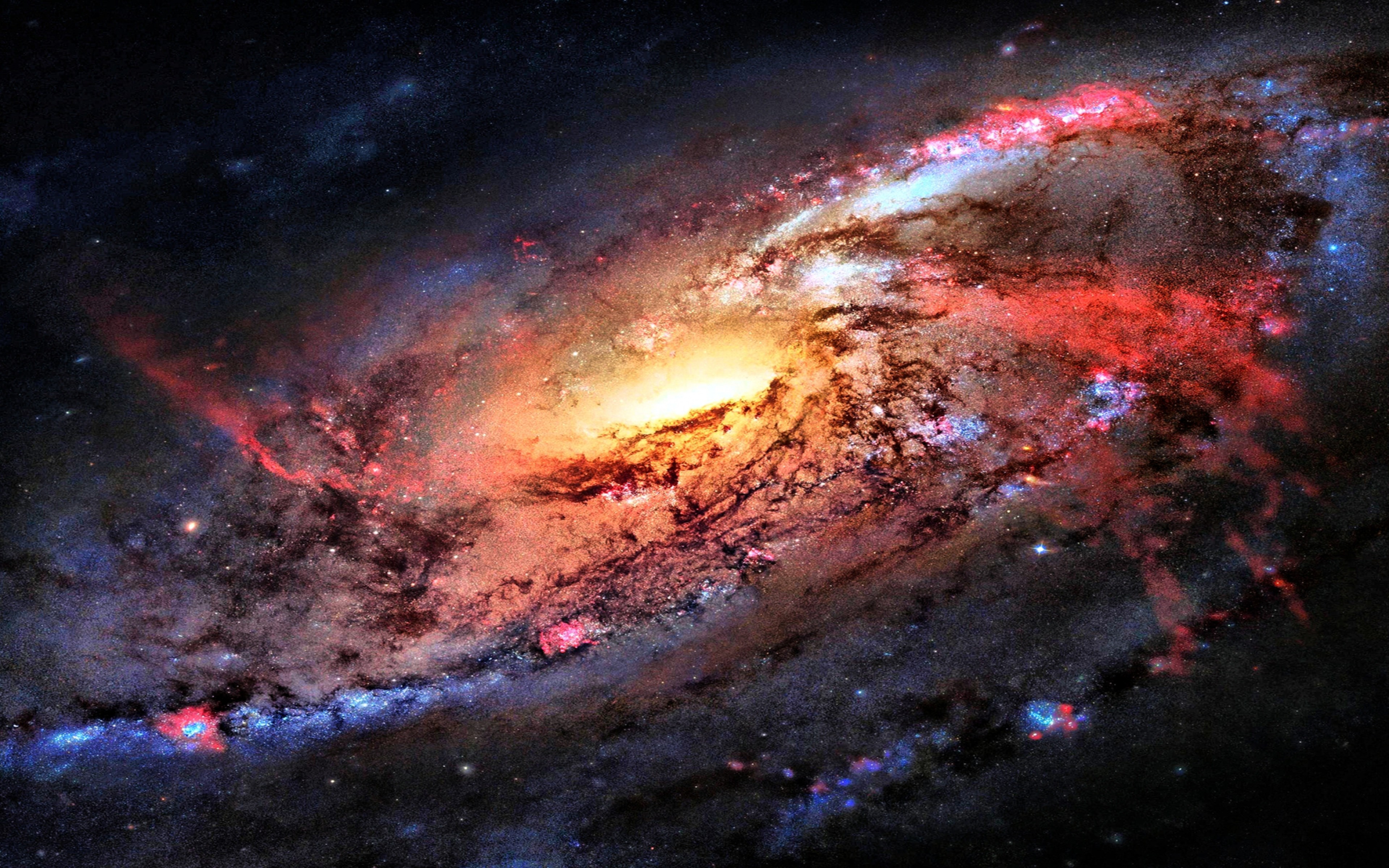 A stunning 4k wallpaper showcasing a spiral galaxy with vibrant colors of red, orange, and blue, set against the backdrop of the dark expanse of space