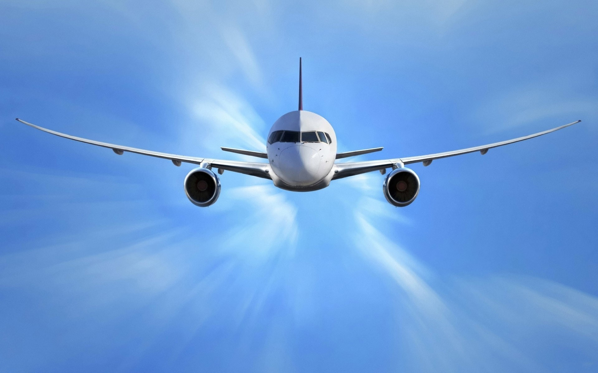 A passenger airliner soaring through a vibrant blue sky, offering a dynamic perspective and showcasing the elegance of modern aviation