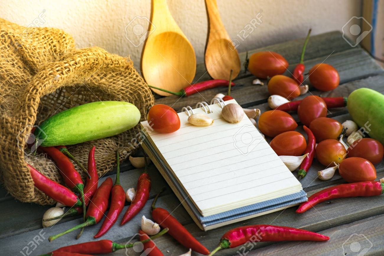 Notepad With Spoons And Vegetable On Wood Background Using