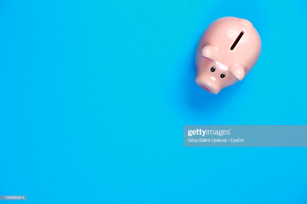 Directly Above Views Of Piggy Bank Over Blue Background High Res