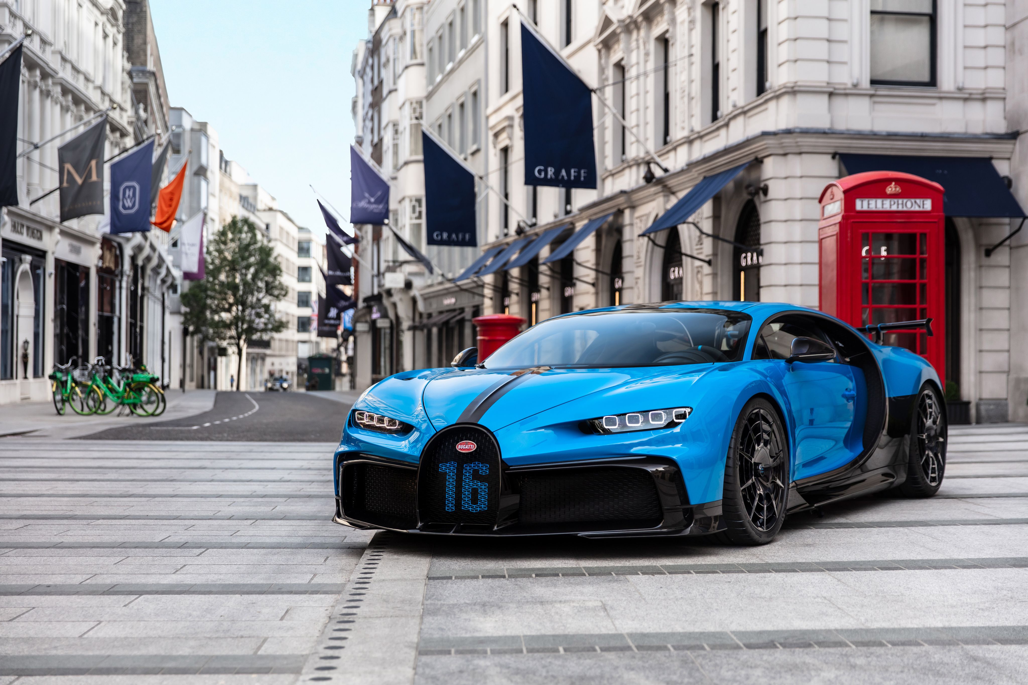 A vibrant blue Bugatti Chiron Pur Sport parked on a London street, showcasing its sleek design and powerful presence