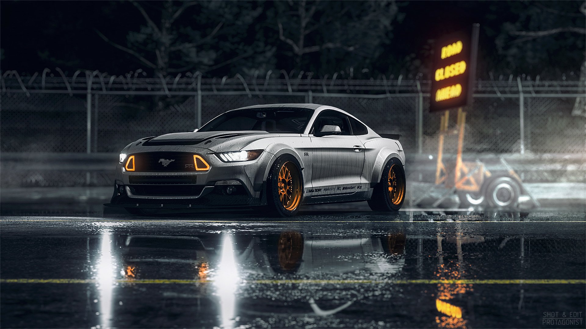 A silver Ford Mustang with custom orange wheels parked on a wet road at night, reflecting in the puddles. A 