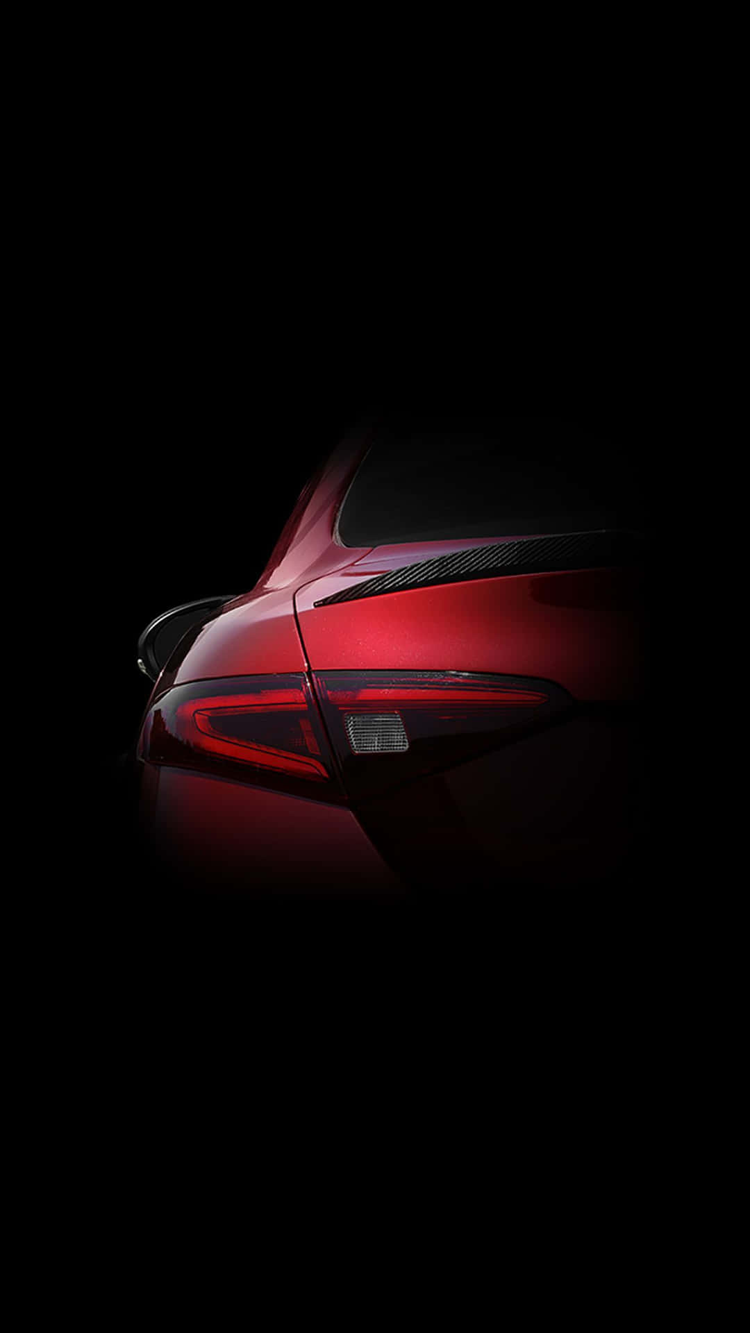 A Powerful Sleek Red Car Against Bright Blue Sky Wallpaper