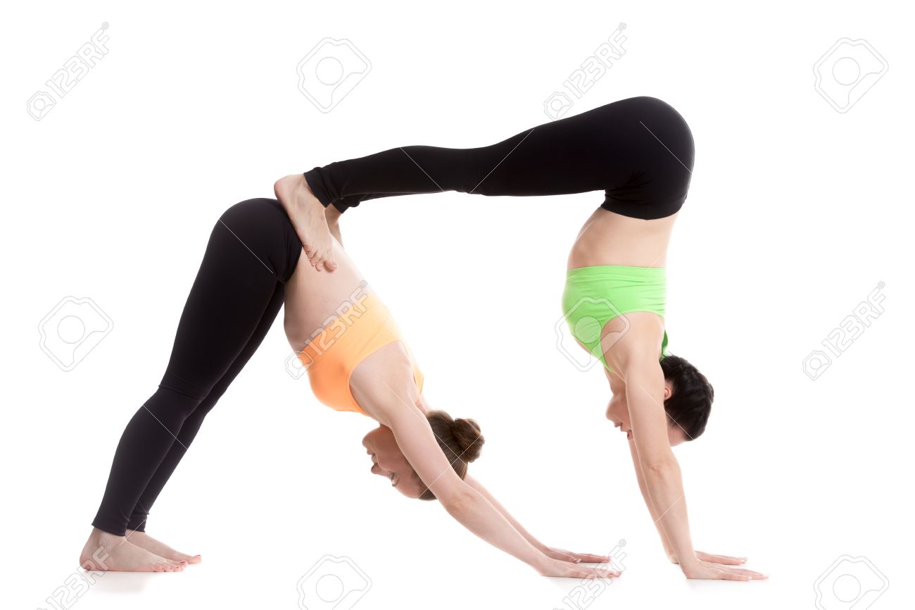 Two Sporty Girl On White Background Doing Acroyoga Yoga With
