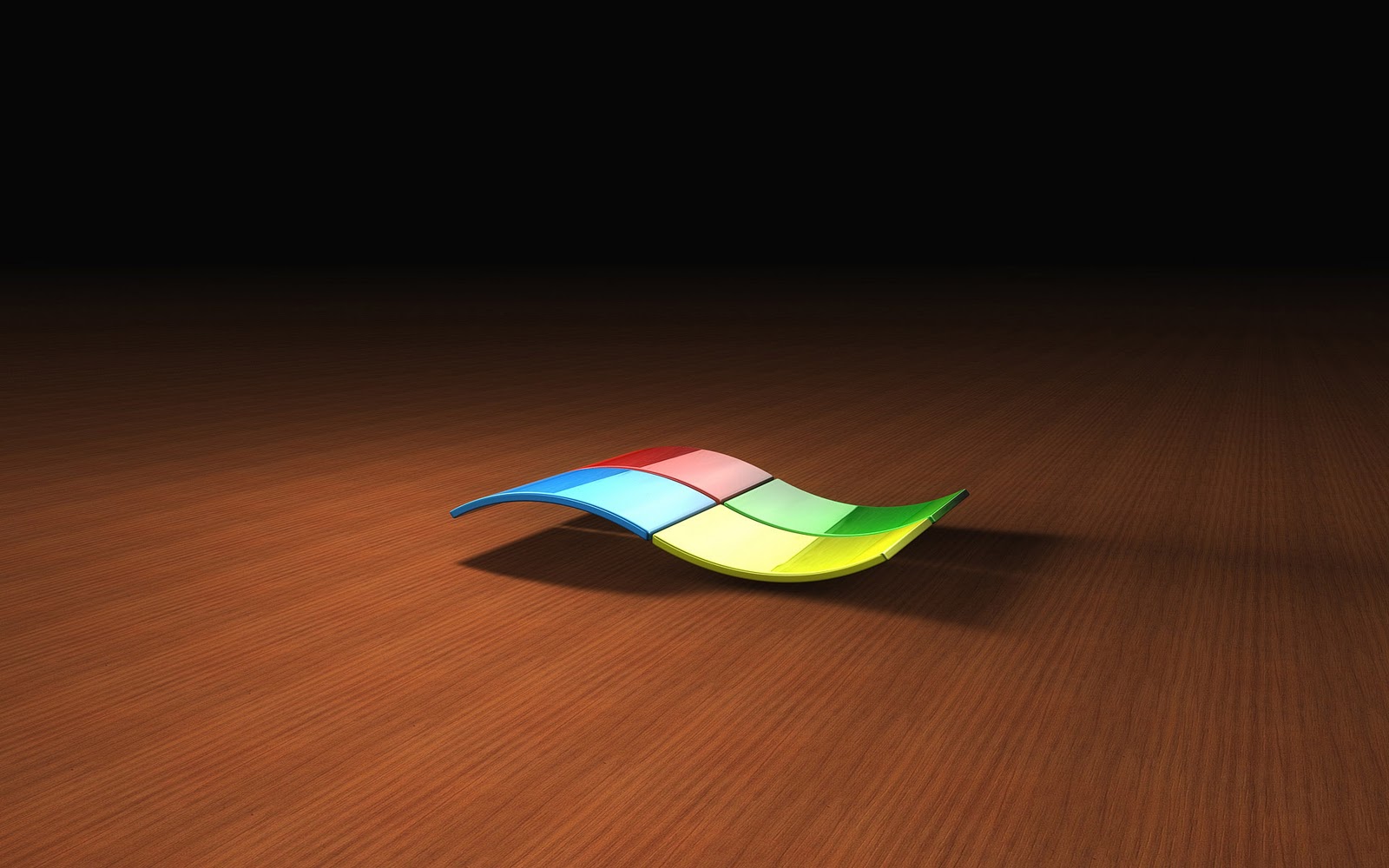 A 3D rendering of the Windows logo, elegantly curved and resting on a polished wooden desktop background