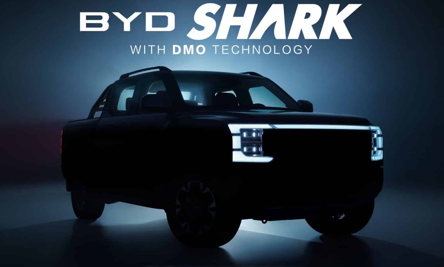 A dimly lit, front-angled view of the BYD Shark pickup truck, highlighting its sleek silhouette and futuristic LED headlights