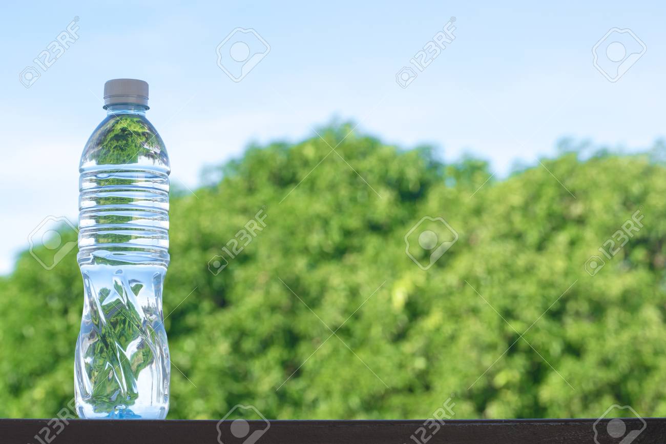Bottle Water Made To Plastic On Sky And Tree Blurry Background