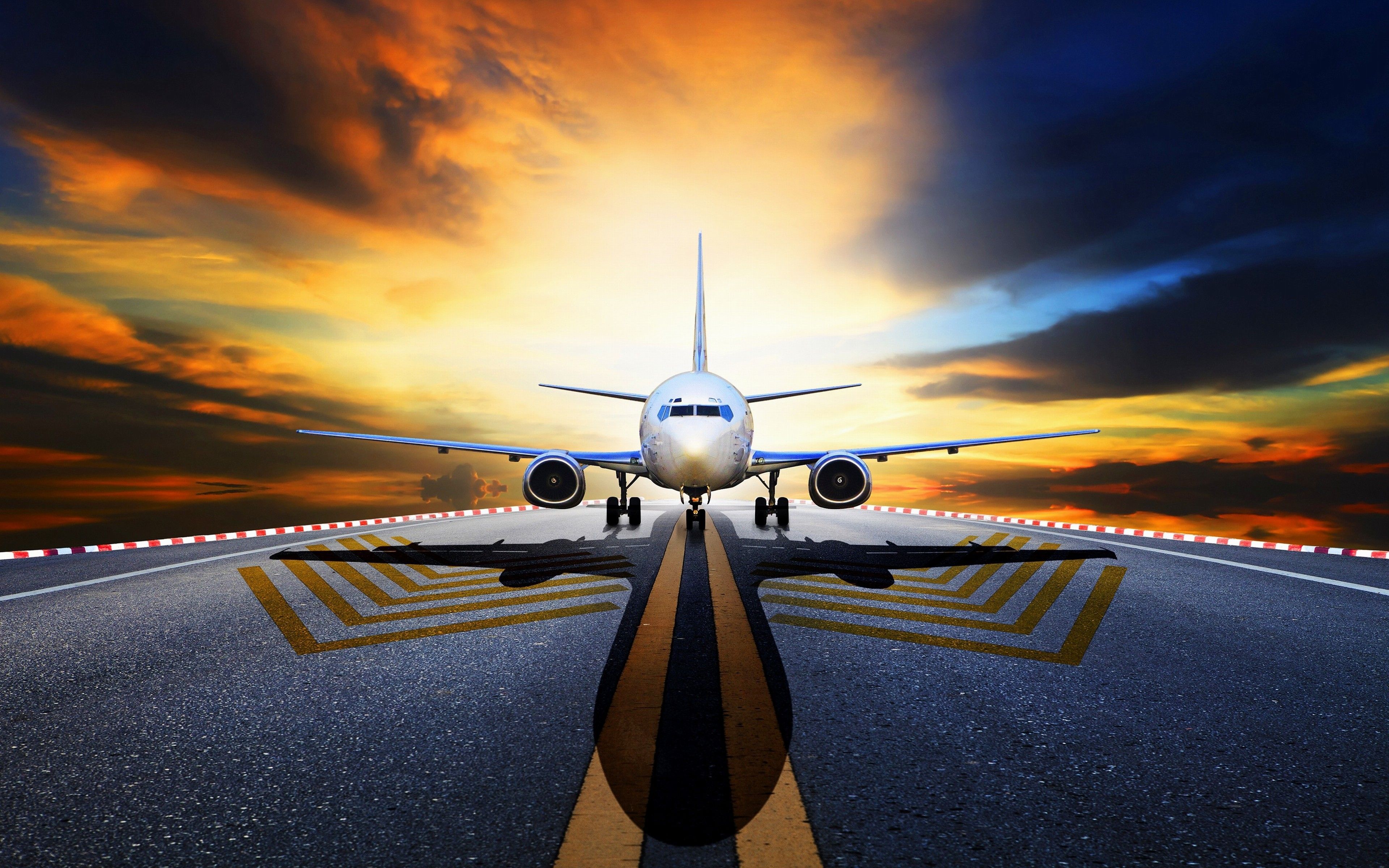 Passenger airplane on runway during sunset