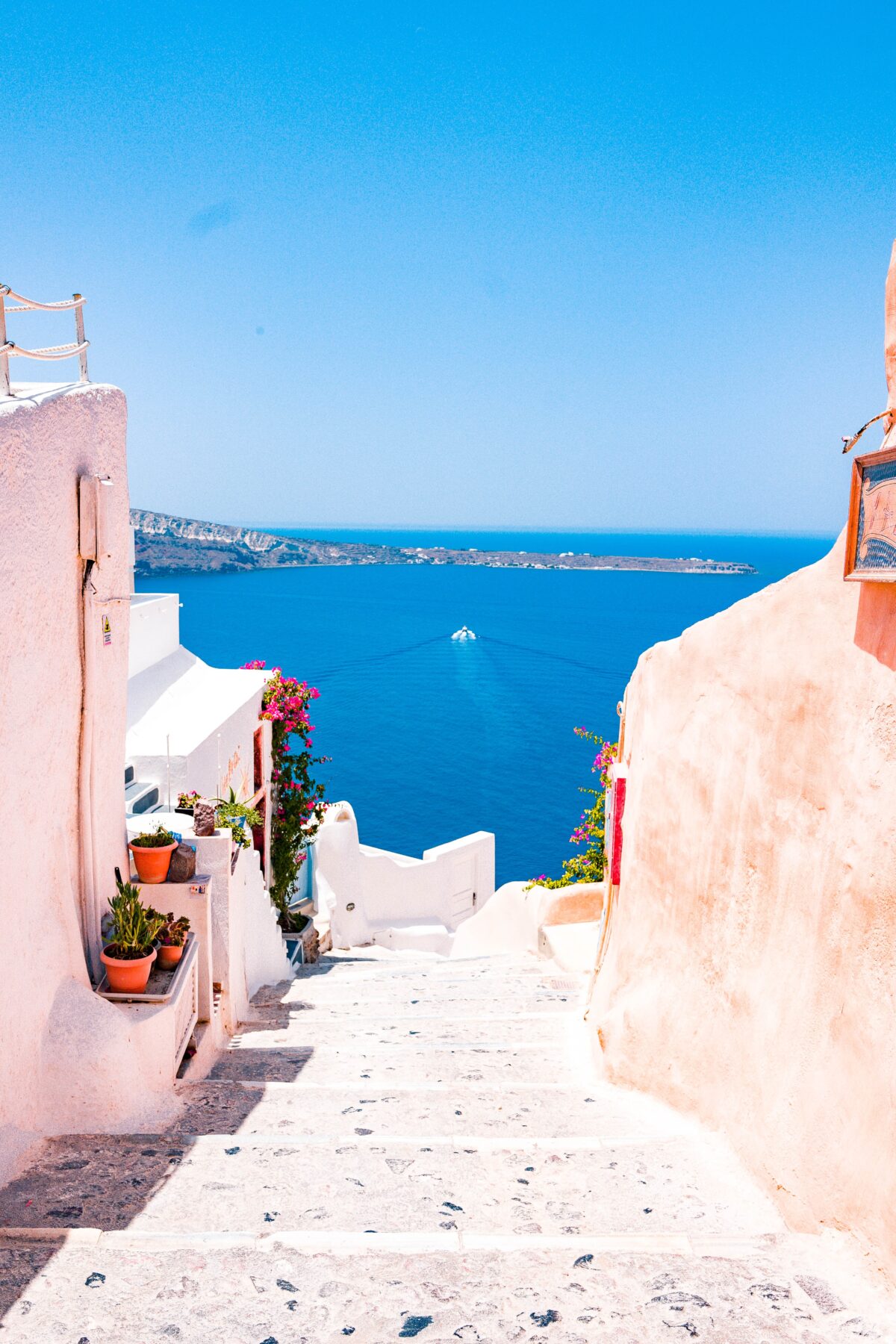 Scenic view of whitewashed buildings and steps leading down to the Aegean Sea in Santorini, Greece