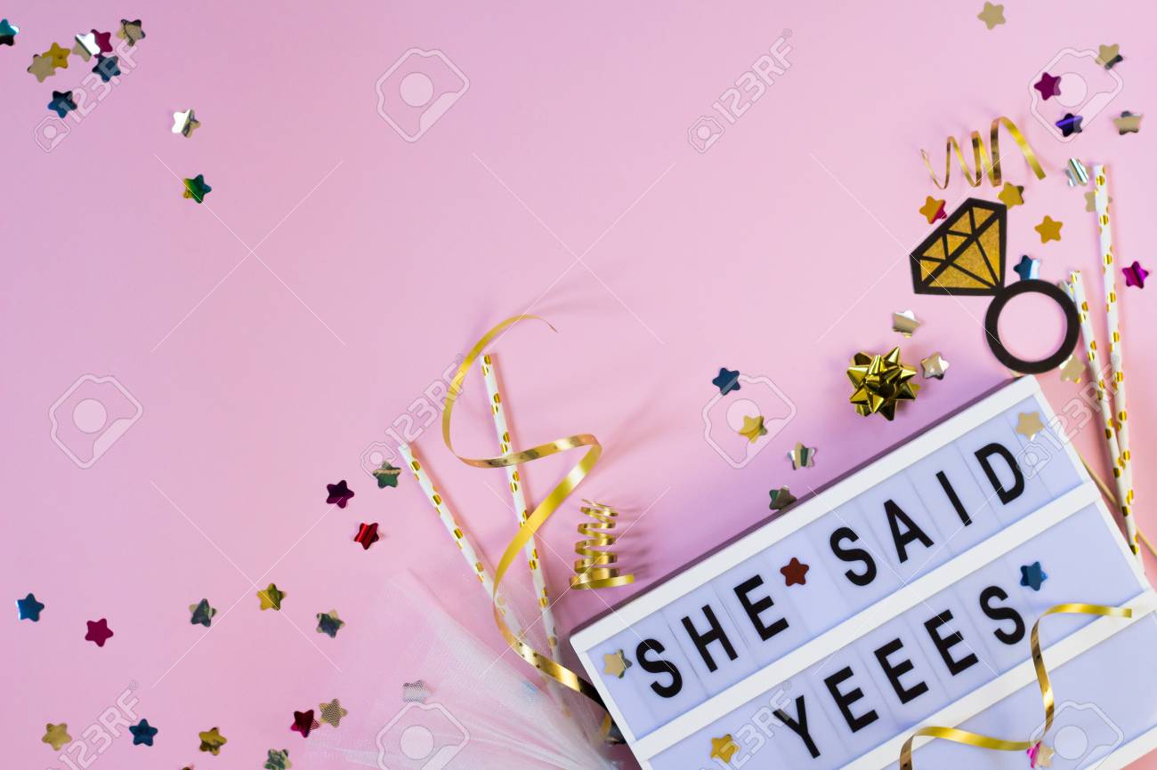 free-download-she-said-yes-text-with-confetti-and-props-on-pink