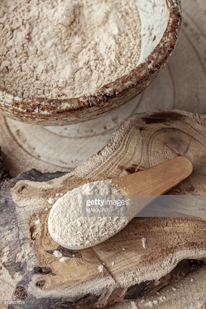 Bowl Of Baobab Powder On Rustic Wood Tray Background Stock Photo