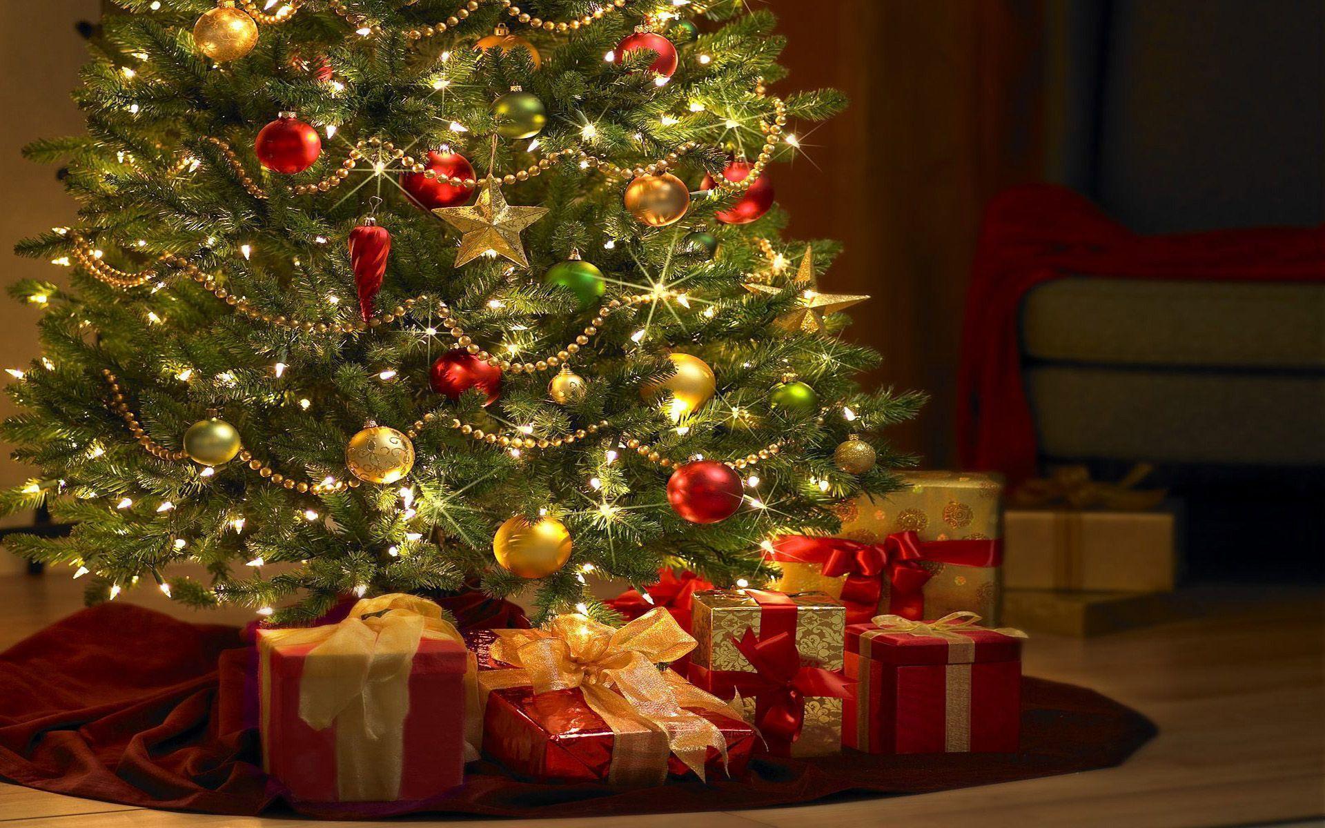 A beautifully decorated Christmas tree with colorful ornaments, twinkling lights, and presents underneath