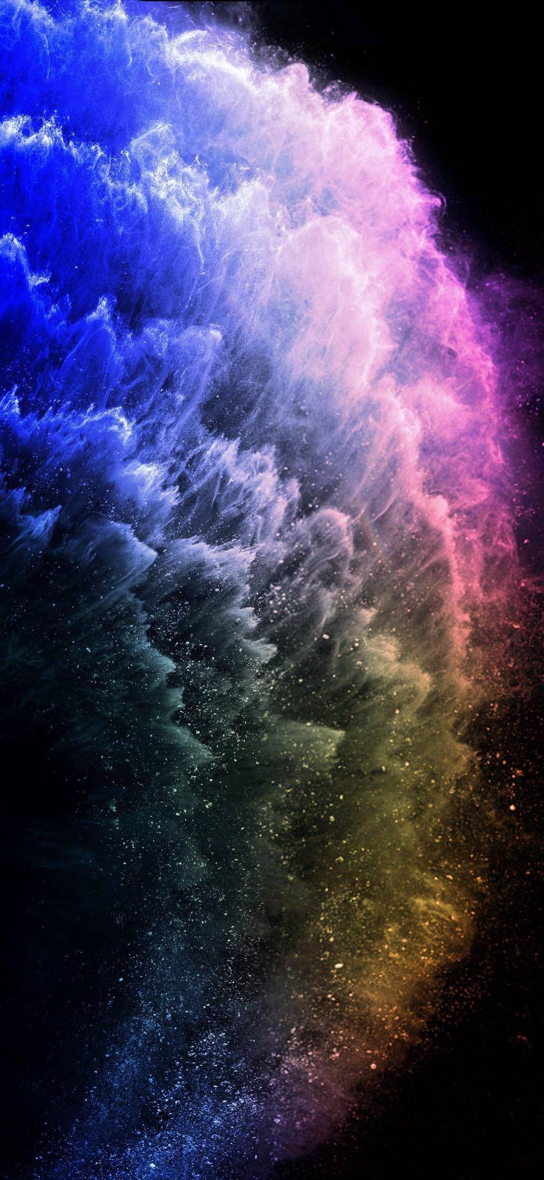 Abstract image of colorful smoke or dust against a black background, resembling a nebula or galaxy