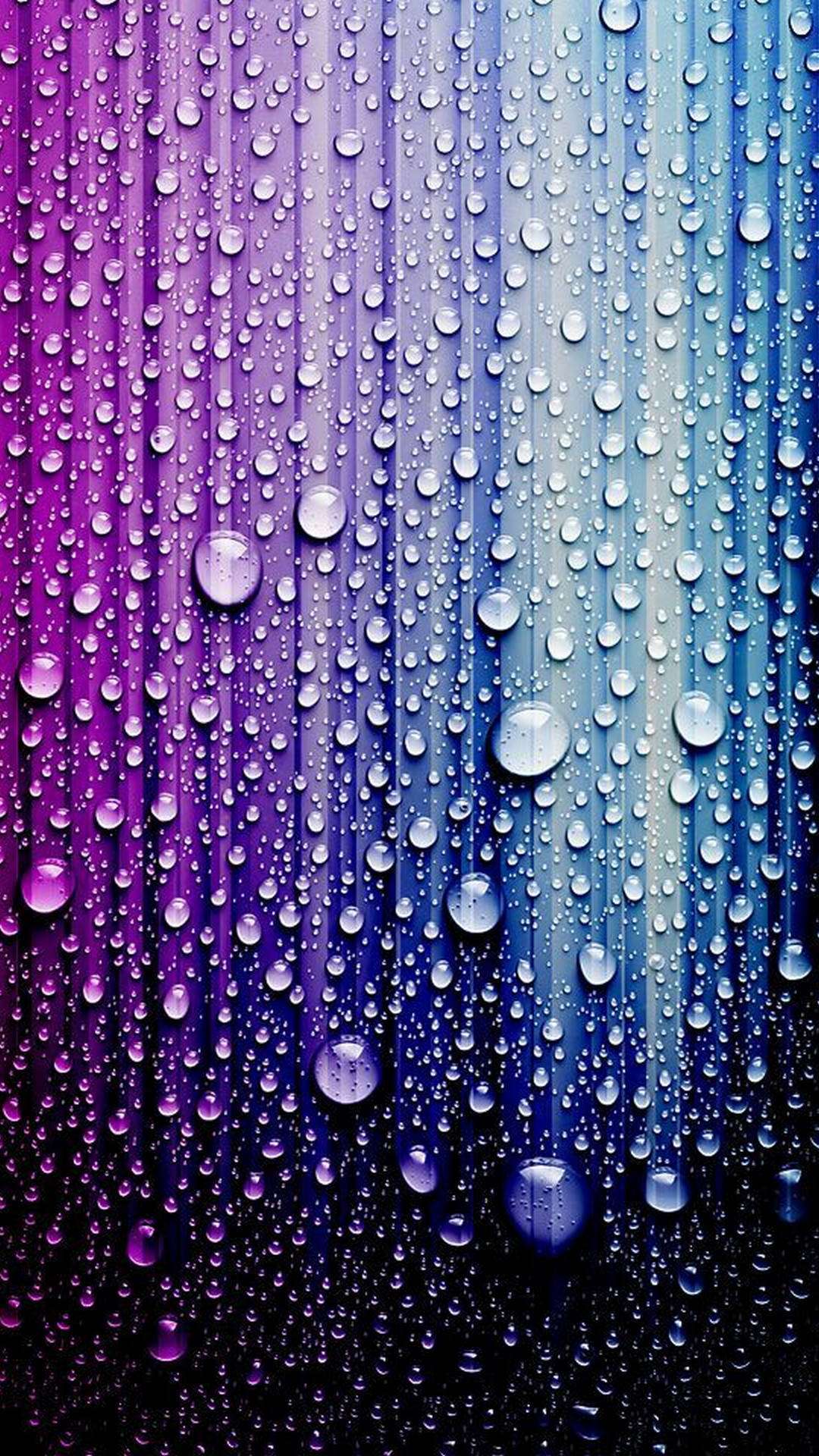 Close-up of water droplets on a vibrant, colorful surface, showcasing a gradient of purple and blue hues. The droplets create a textured effect, reflecting light and adding depth to the image