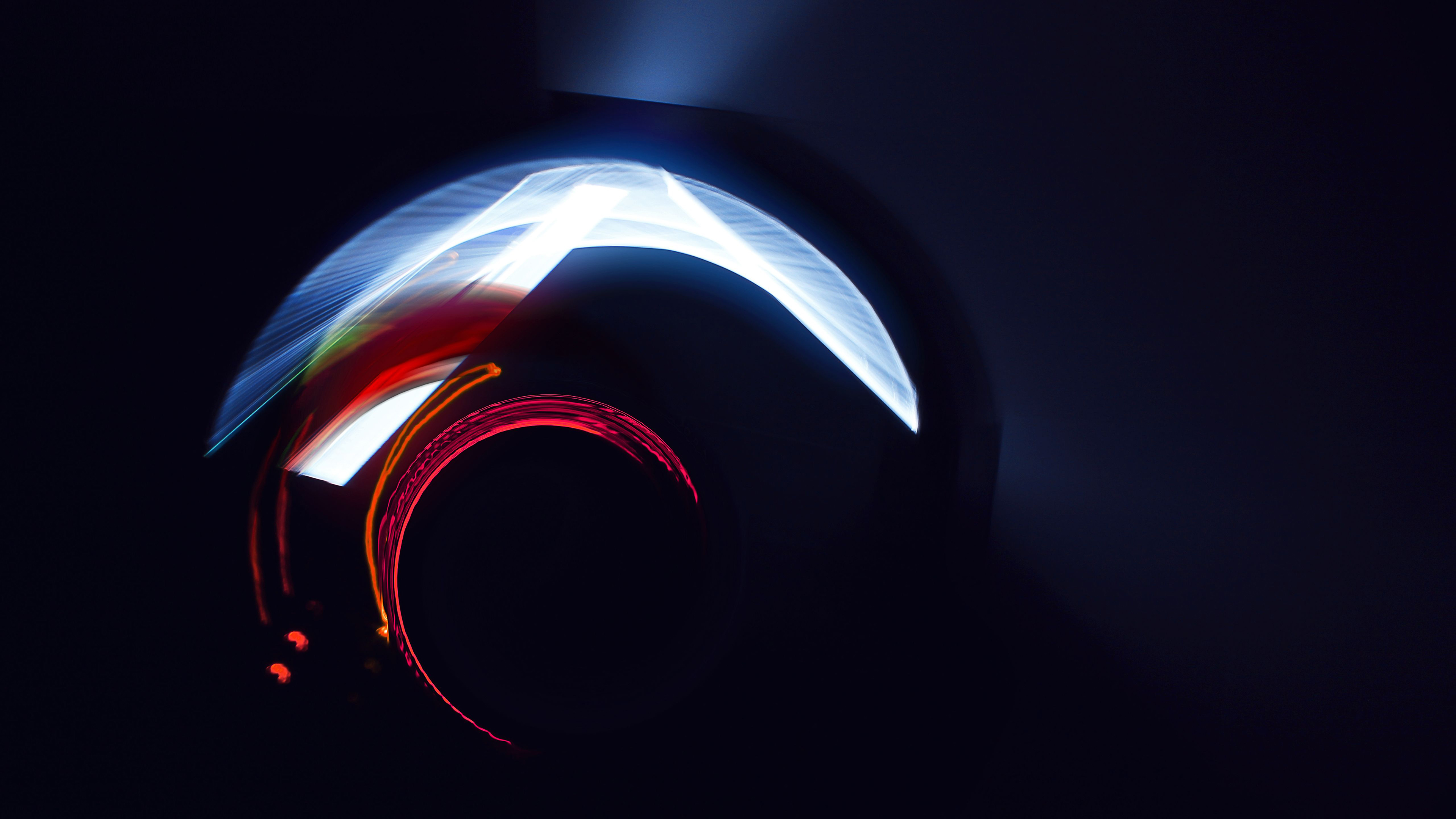 Abstract light trails forming a dynamic and colorful design against a dark background, suitable for a 4K wallpaper