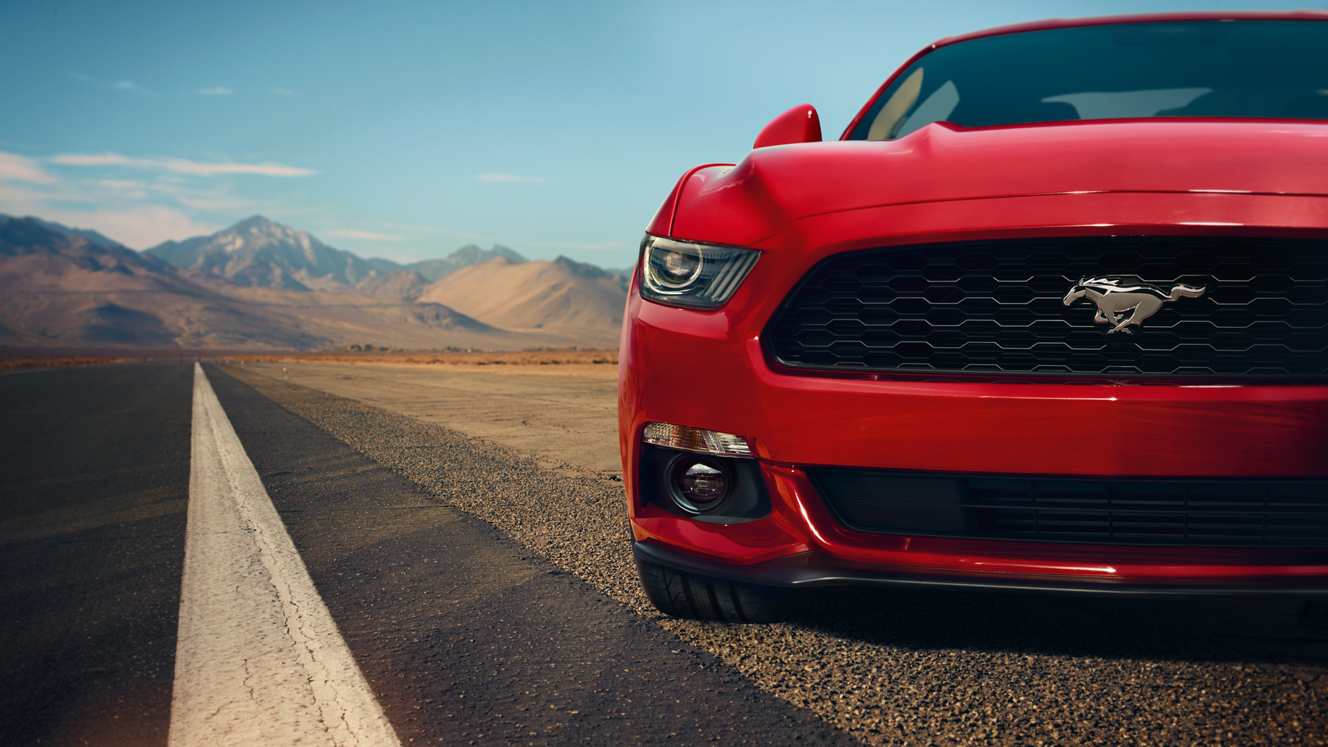 Red Ford Mustang on a desert road
