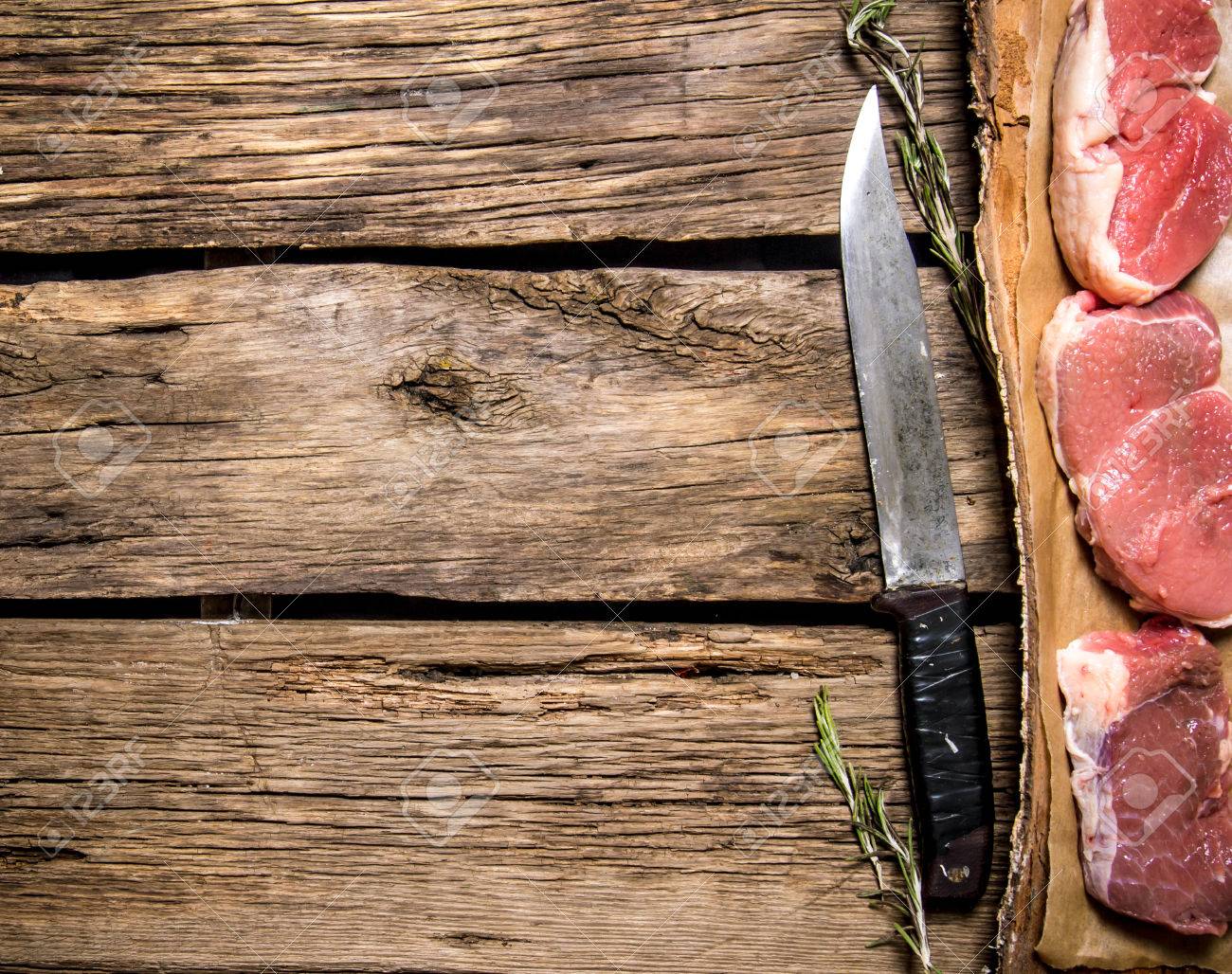 Free download Pieces Of Raw Meat With A Butcher Knife On Wooden