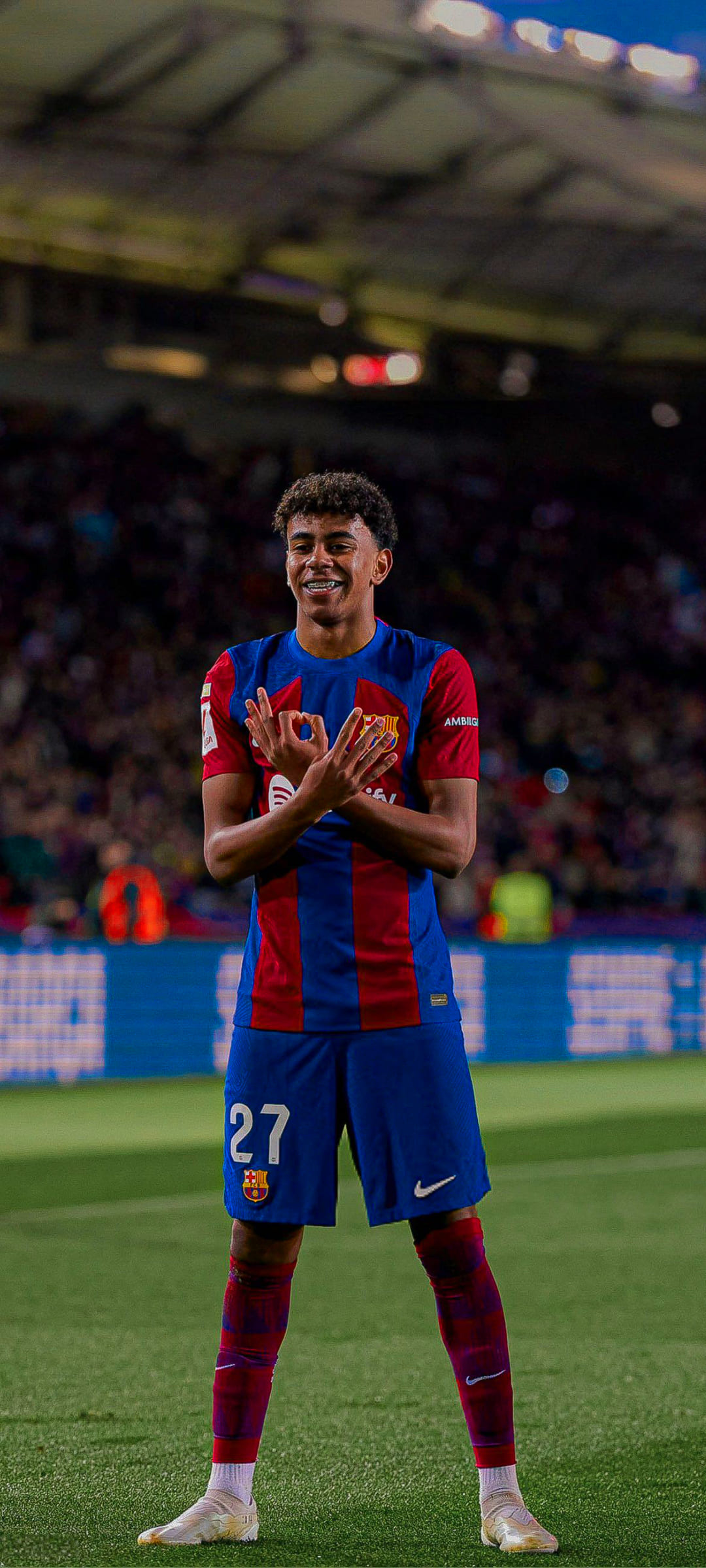 Lamine Yamal of FC Barcelona, making a hand gesture on the field