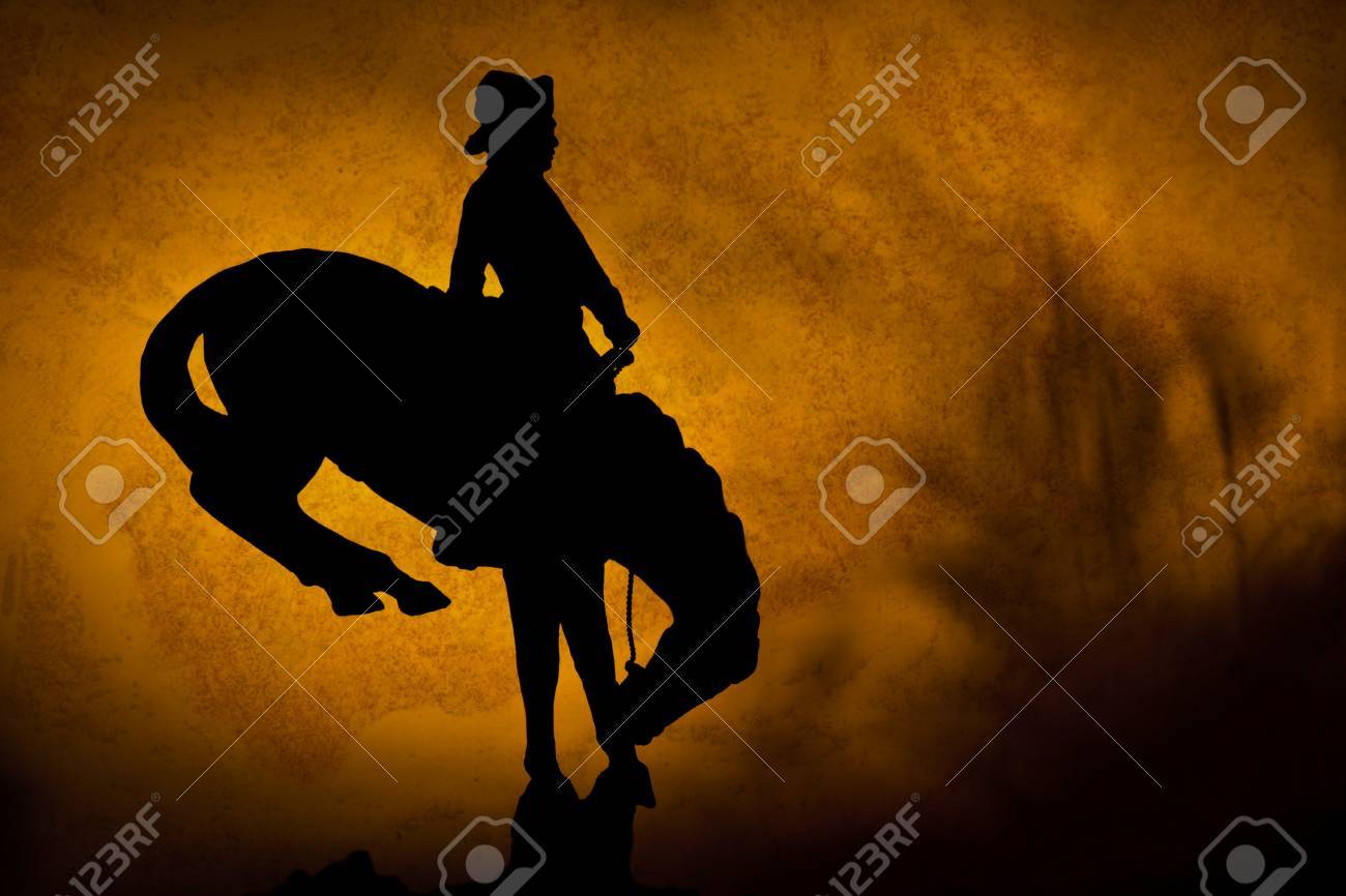 Silhouette Of Cowboy On A Bucking Bronco Orange Yellow Sunset