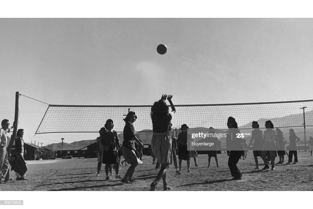 Young Women Playing Volleyball Buildings In Background Ansel