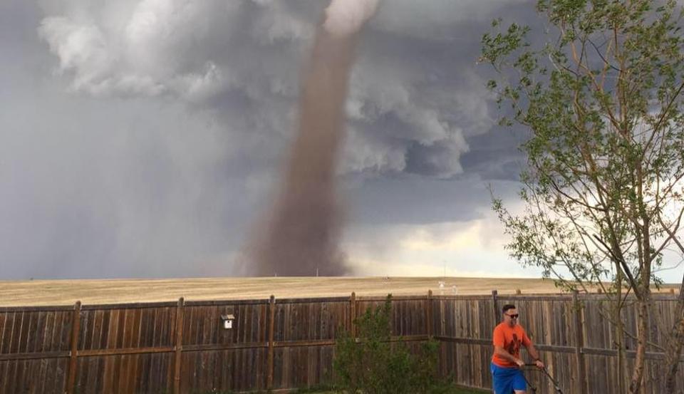 This Photo Of A Man Calmly Mowing Lawn With Tornado In Background