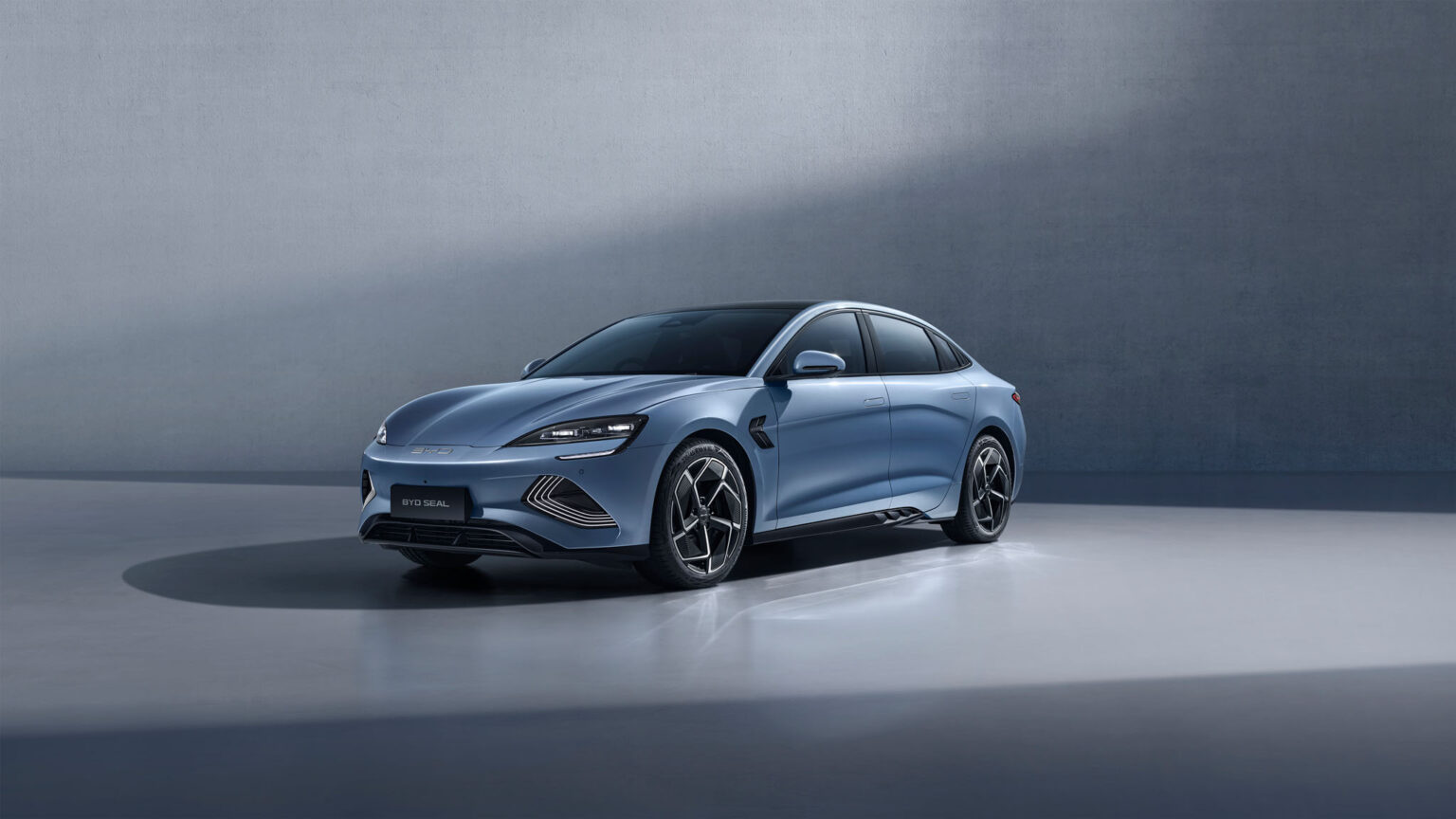 A sleek, light blue BYD Seal electric sedan posed in a minimalist studio setting