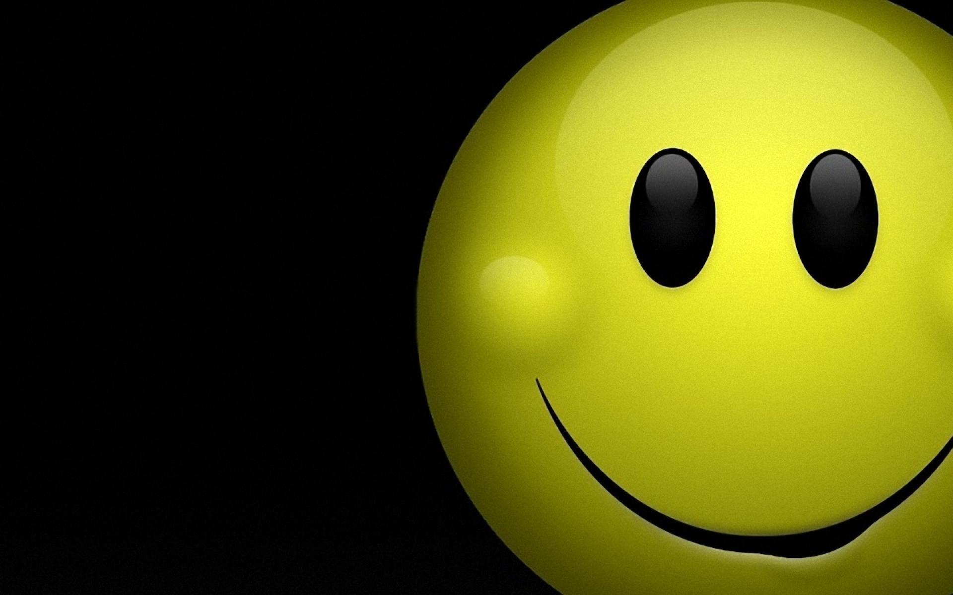 A classic yellow smiley face on a black background, radiating happiness and positivity