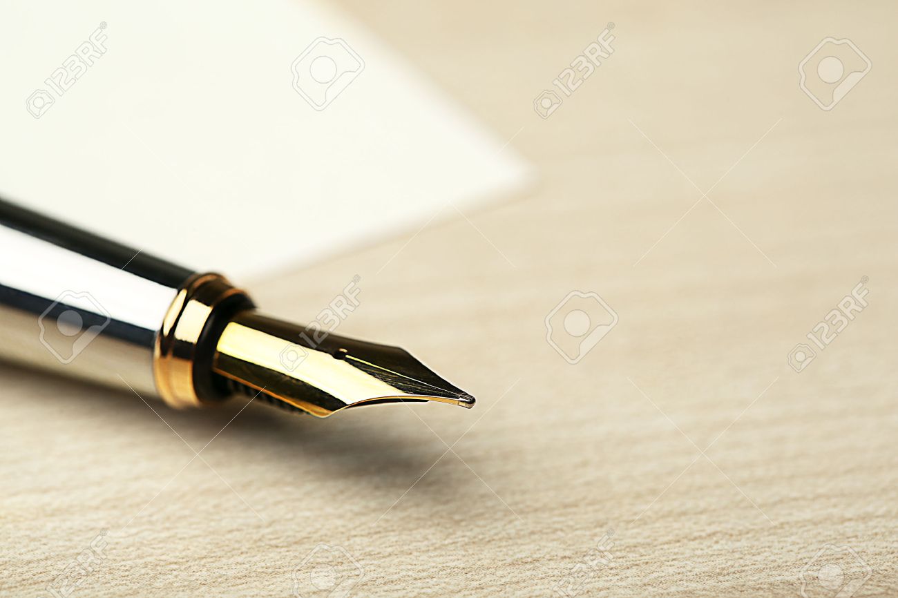 Fountain Pen On White Sheet Of Paper And Wooden Table Background