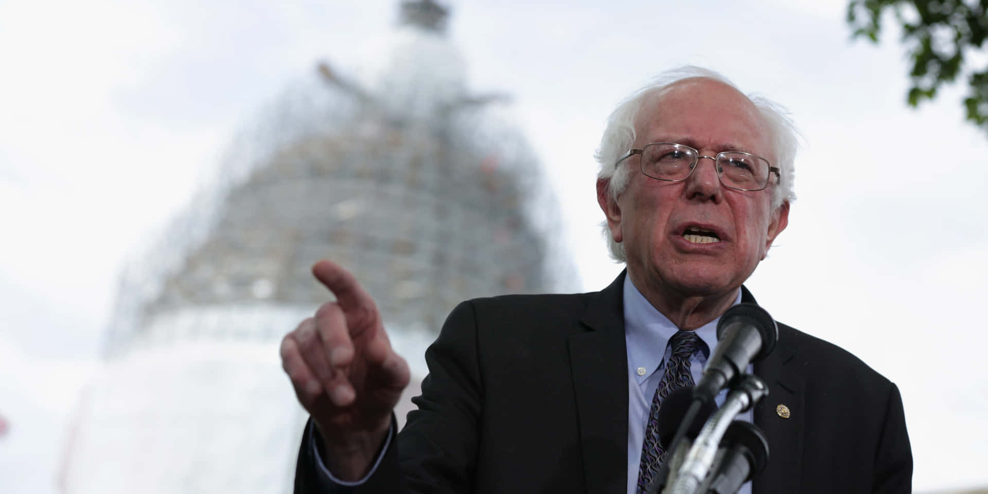 Bernie Sanders Speakingat Podium Wallpaper