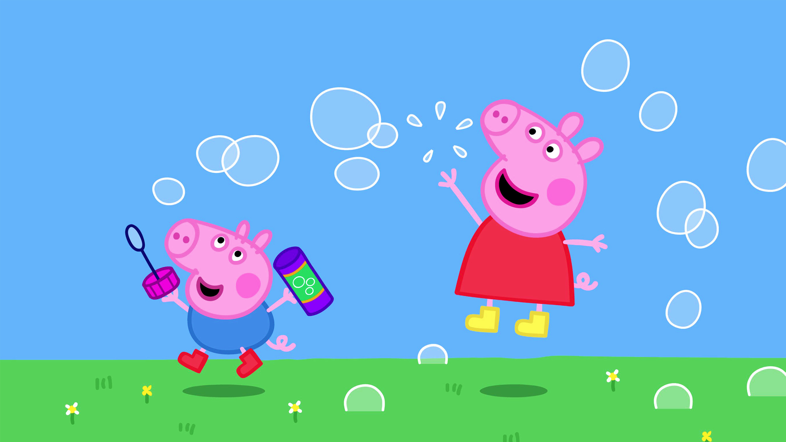 Peppa Pig and George playing with bubbles in a green field under a blue sky
