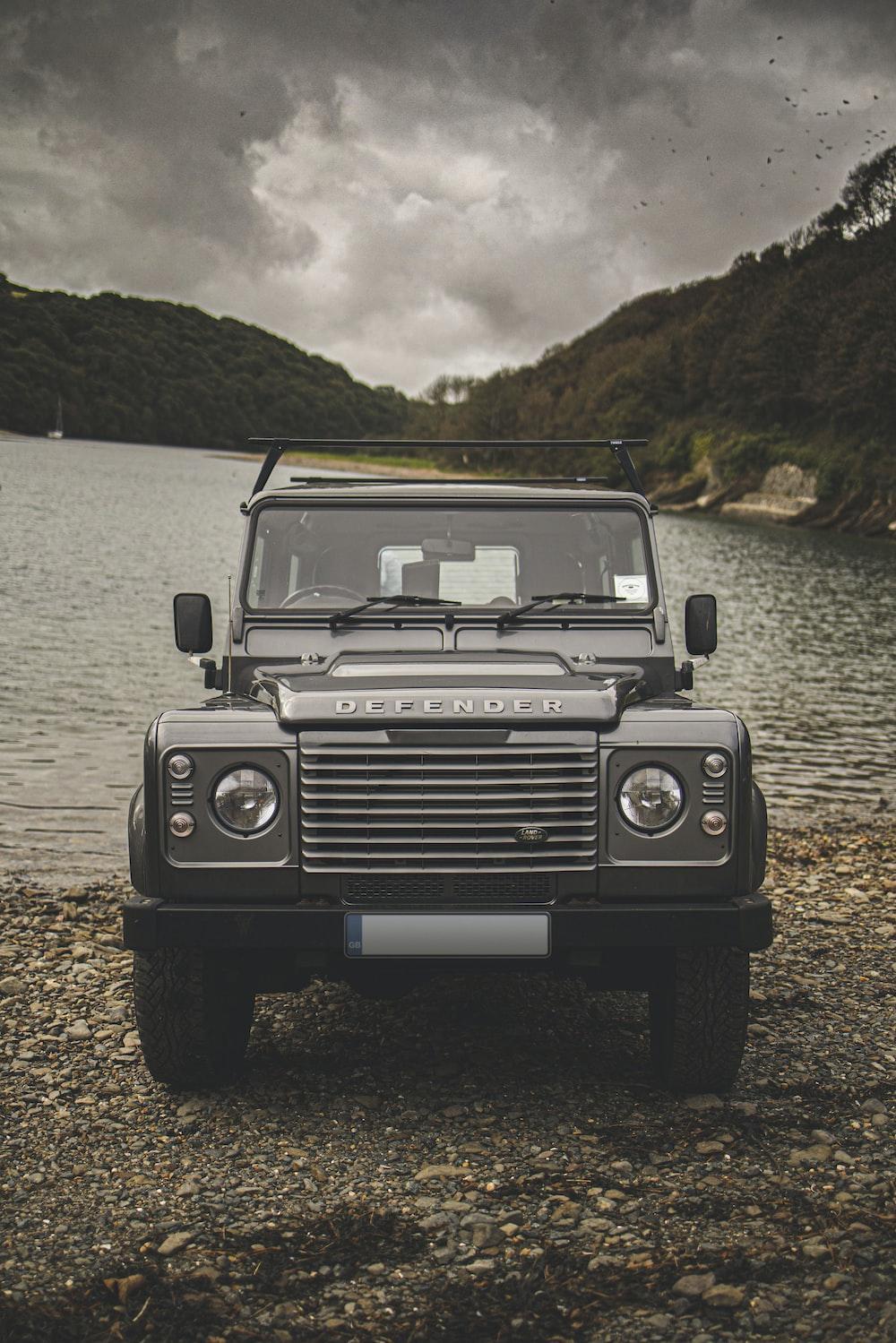 Black Jeep Wrangler On Water During Daytime Photo Grey