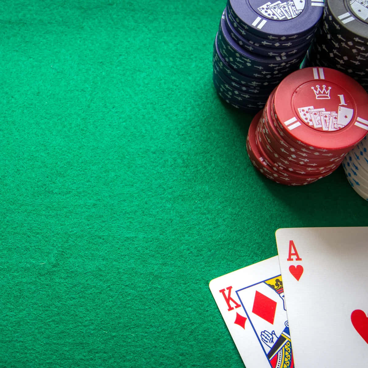 A Lively Poker Night With Chips And Cards On Green Wallpaper