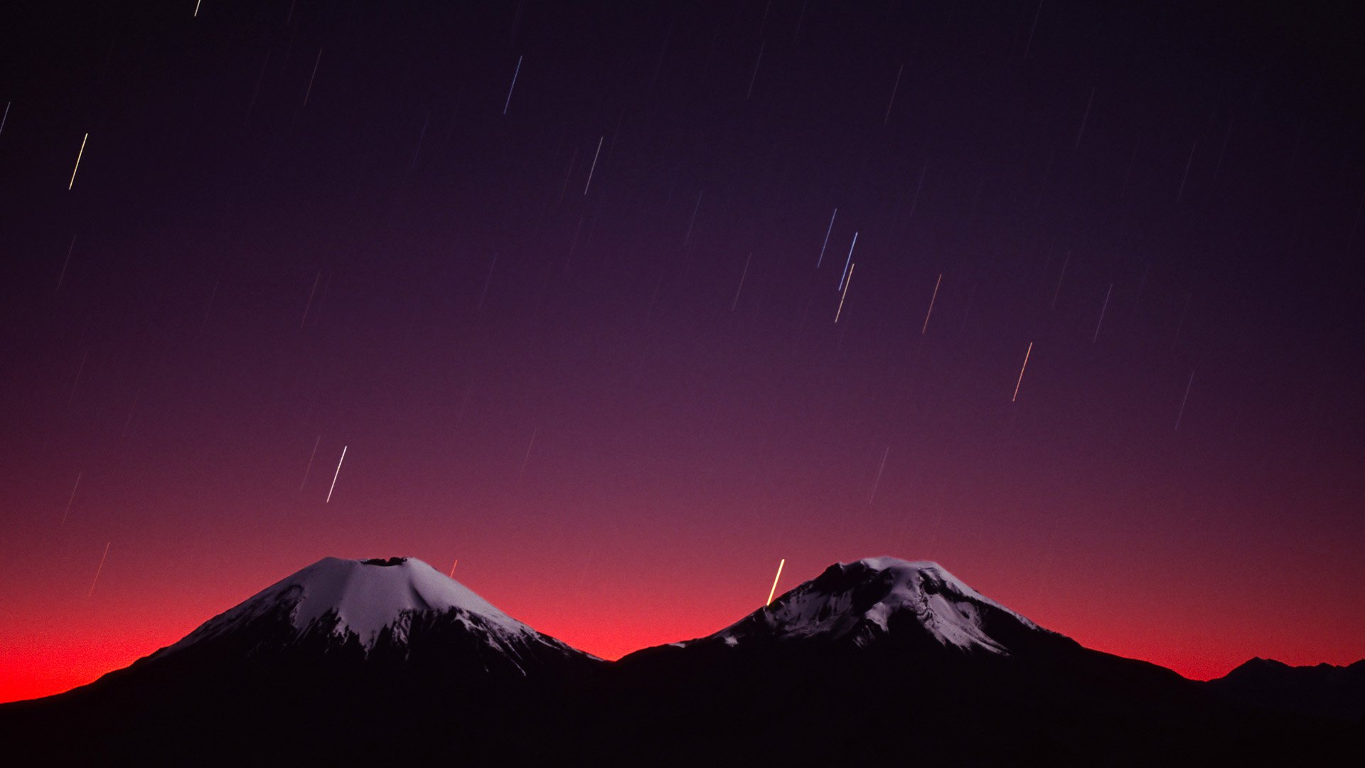 Starlight Streaks Above The Moonlit Payachatas Volcanoes