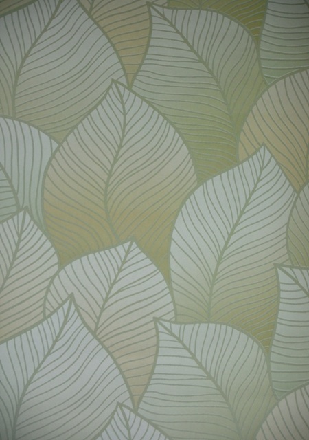 olive green background with large leaf pattern textured wallpaper