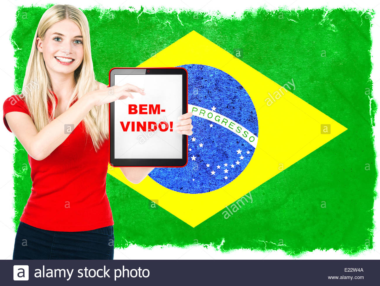 Young Woman With Flag Of Brasil On The Background Holding Tablet