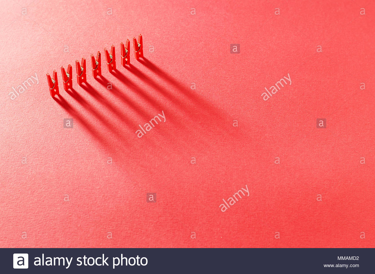Red Laundry Clips Organized In A Row Over Background Stock