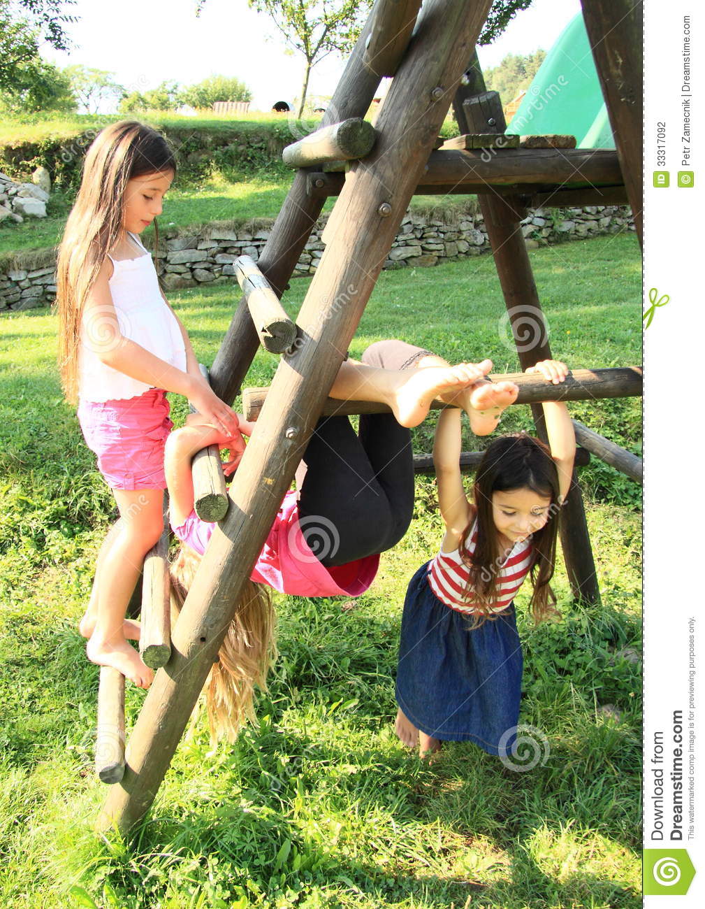 Little kids girls playing on wooden constructionLittle Kids Barefoot
