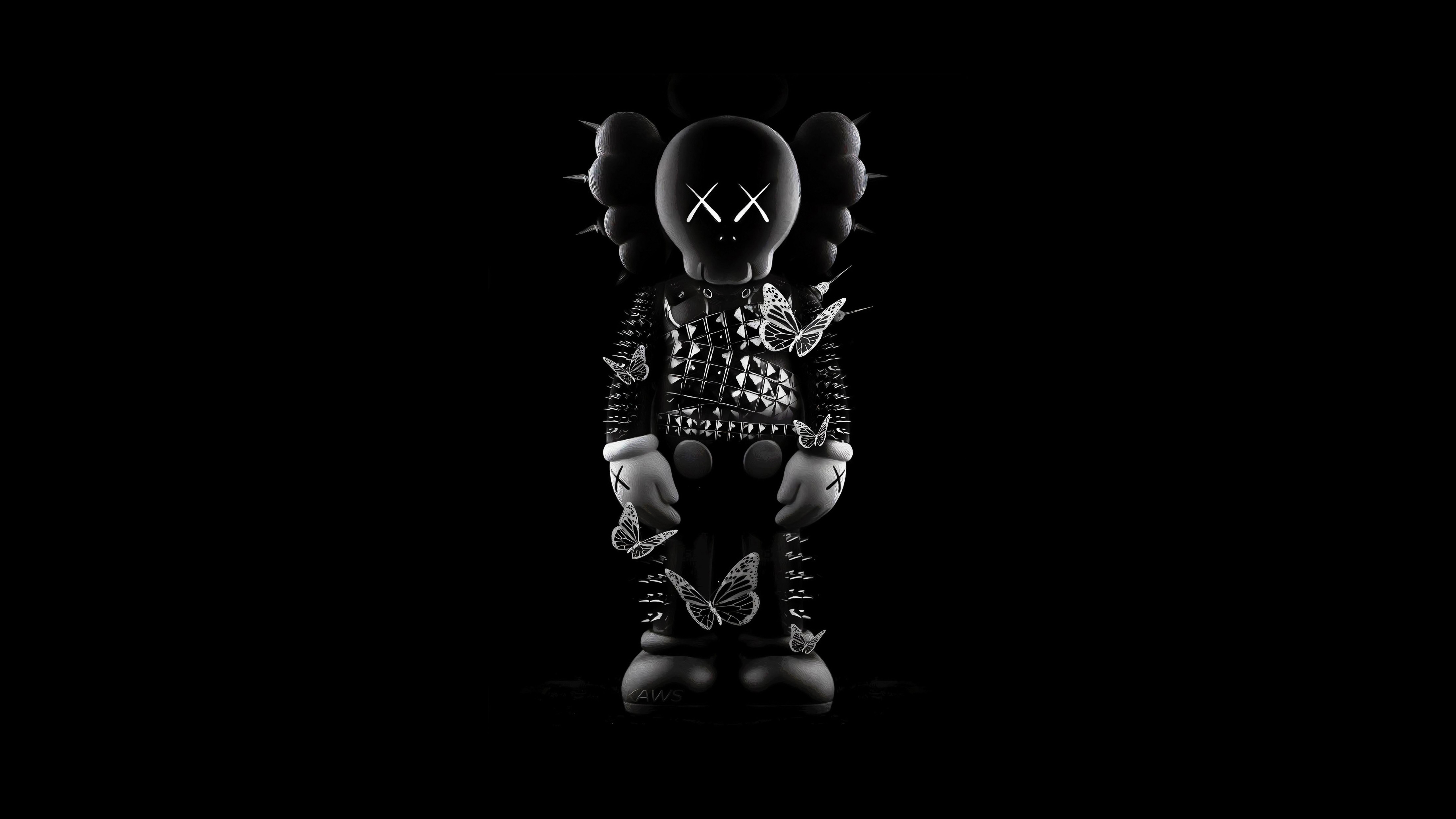 A dramatic black and white image of a KAWS Companion figure against a dark background. The figure is adorned with a studded jacket and has butterflies surrounding it, creating a striking visual contrast