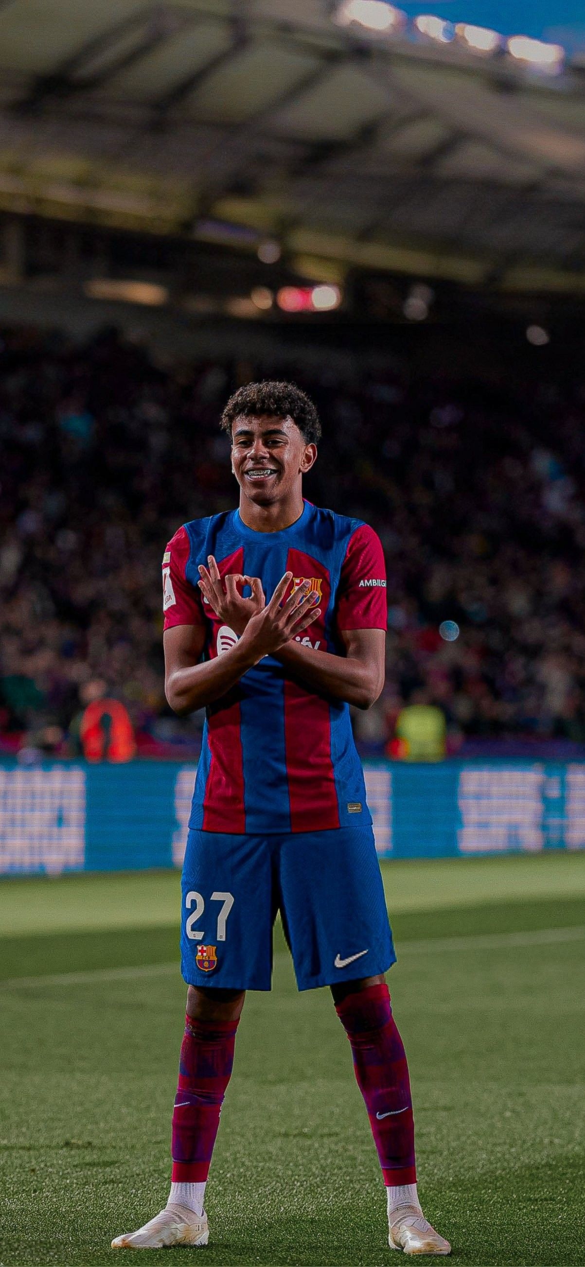 Lamine Yamal of FC Barcelona in action during a match. He is smiling and gesturing with his hands