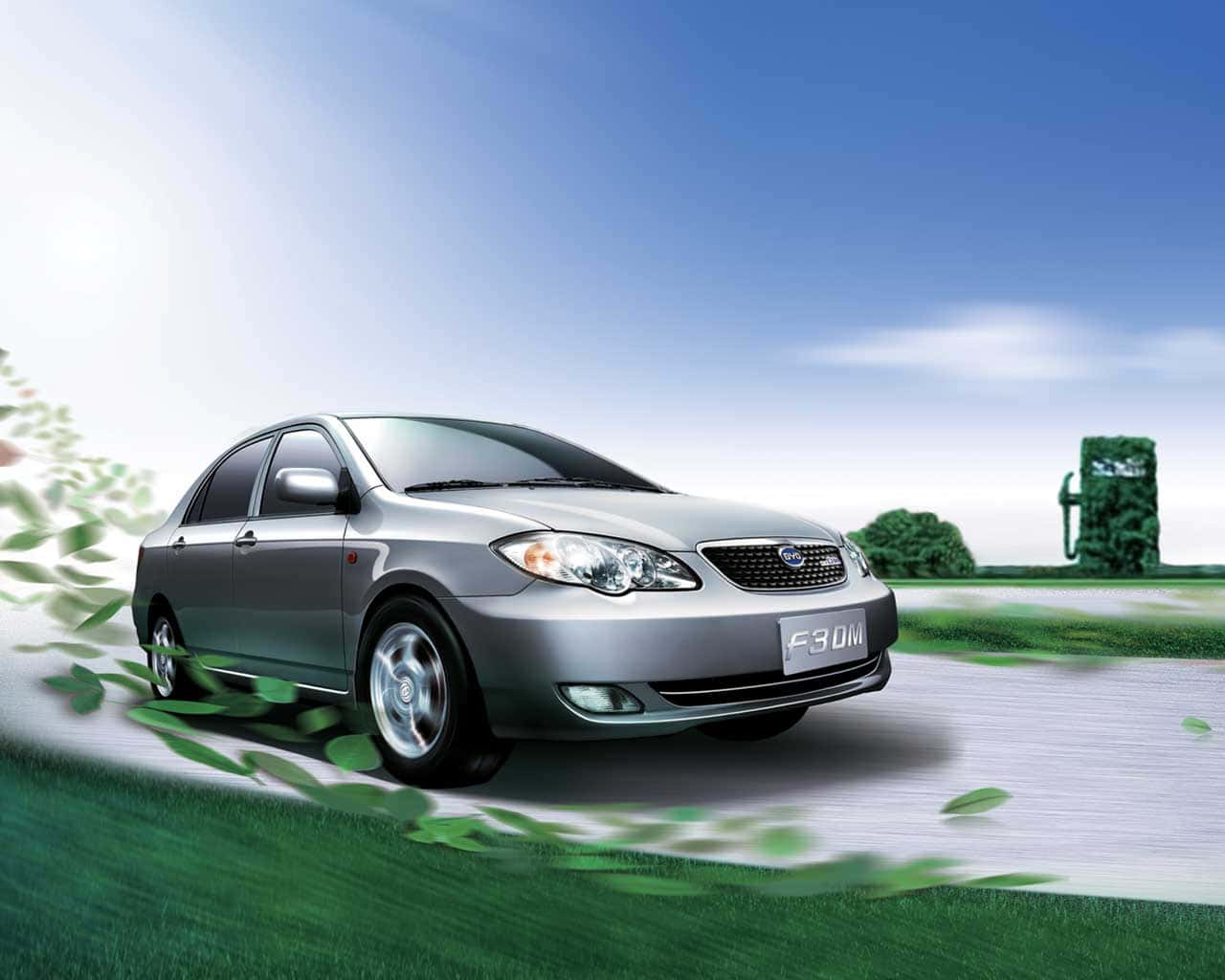 Silver BYD F3DM sedan driving on a scenic road