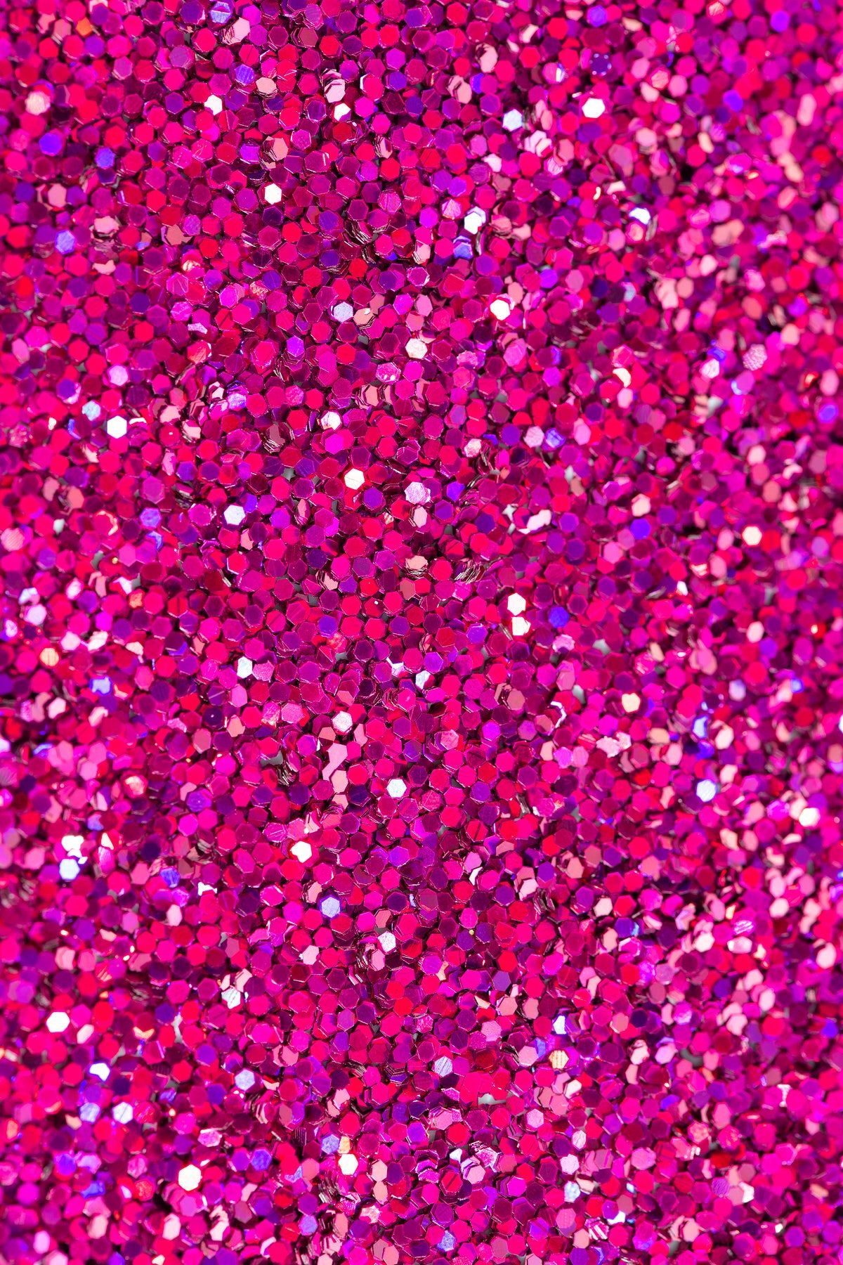 Close-up of vibrant pink glitter, showcasing its sparkly and textured surface