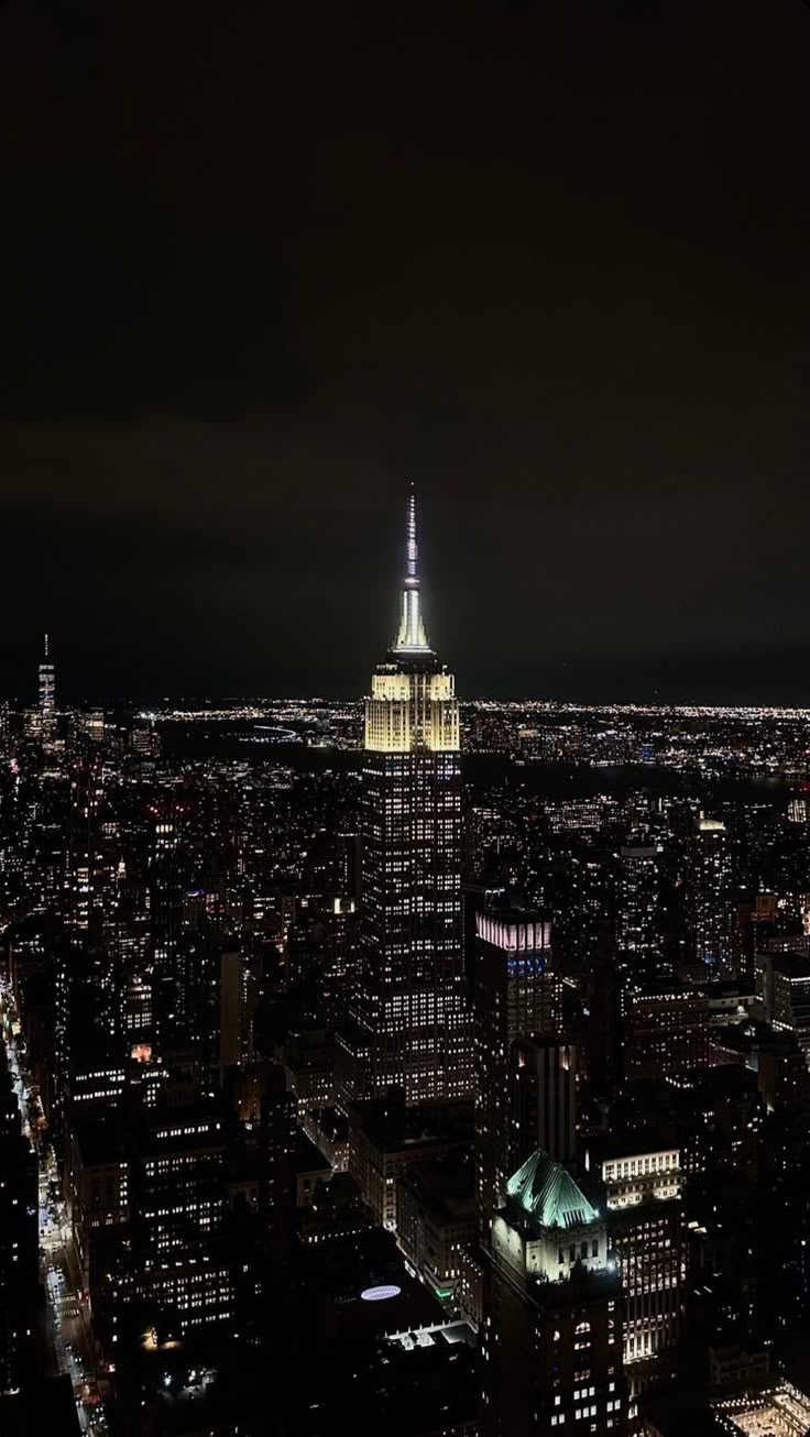 Empire Building Lit Up At Night In New York City Wallpaper
