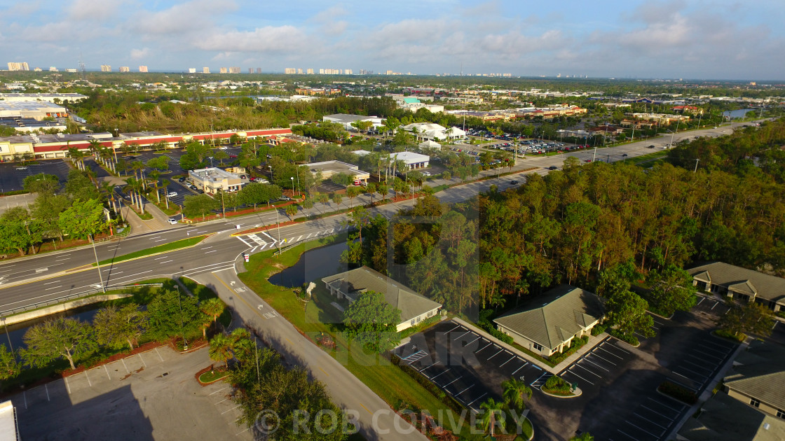 Aerial Of Suburban Setting W High Rise In Background License