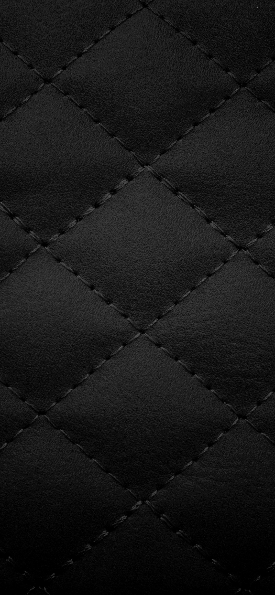 Close-up of black quilted leather texture