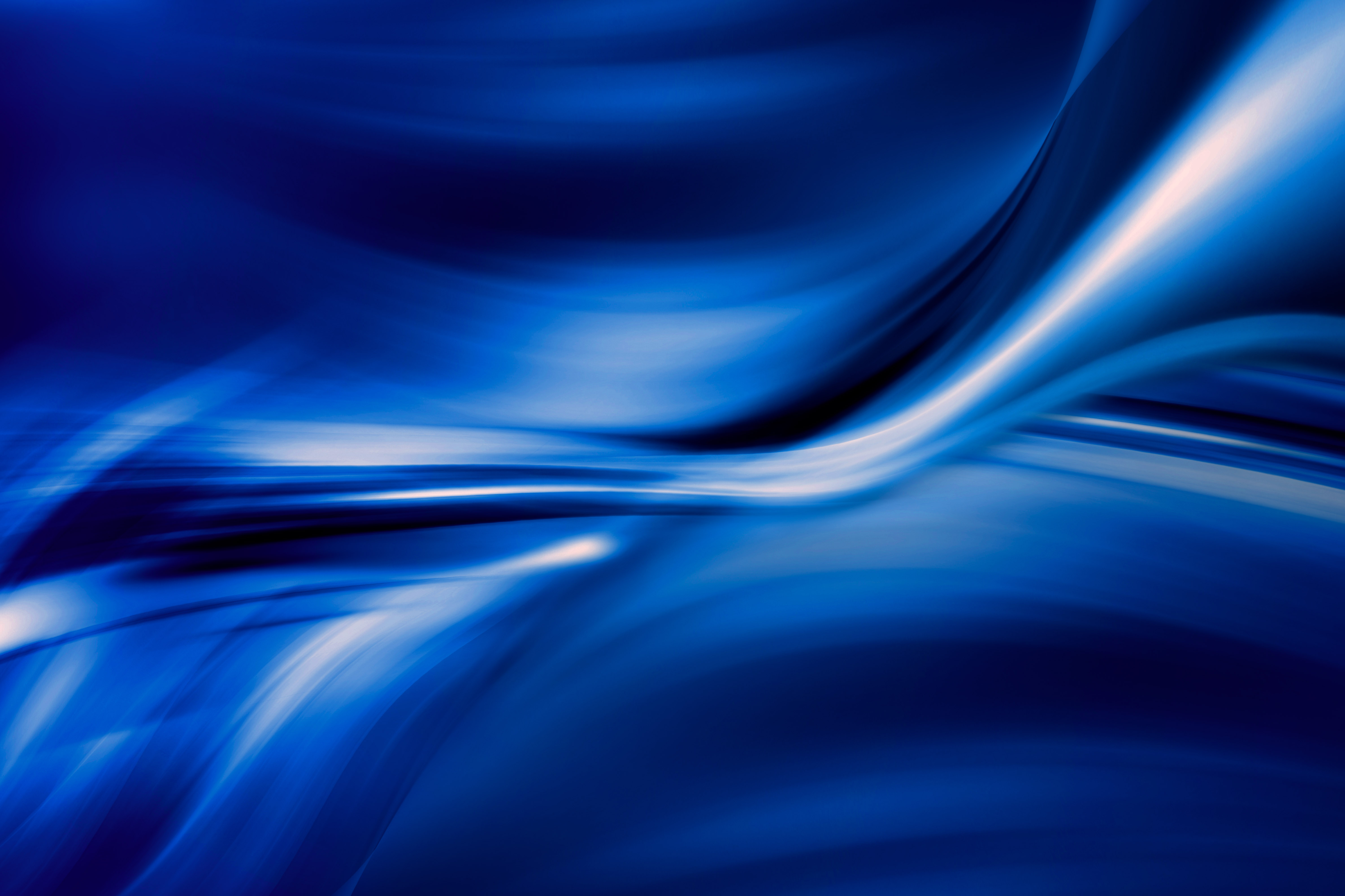 Abstract blue background with flowing, swirling lines and gradients, creating a dynamic and modern feel